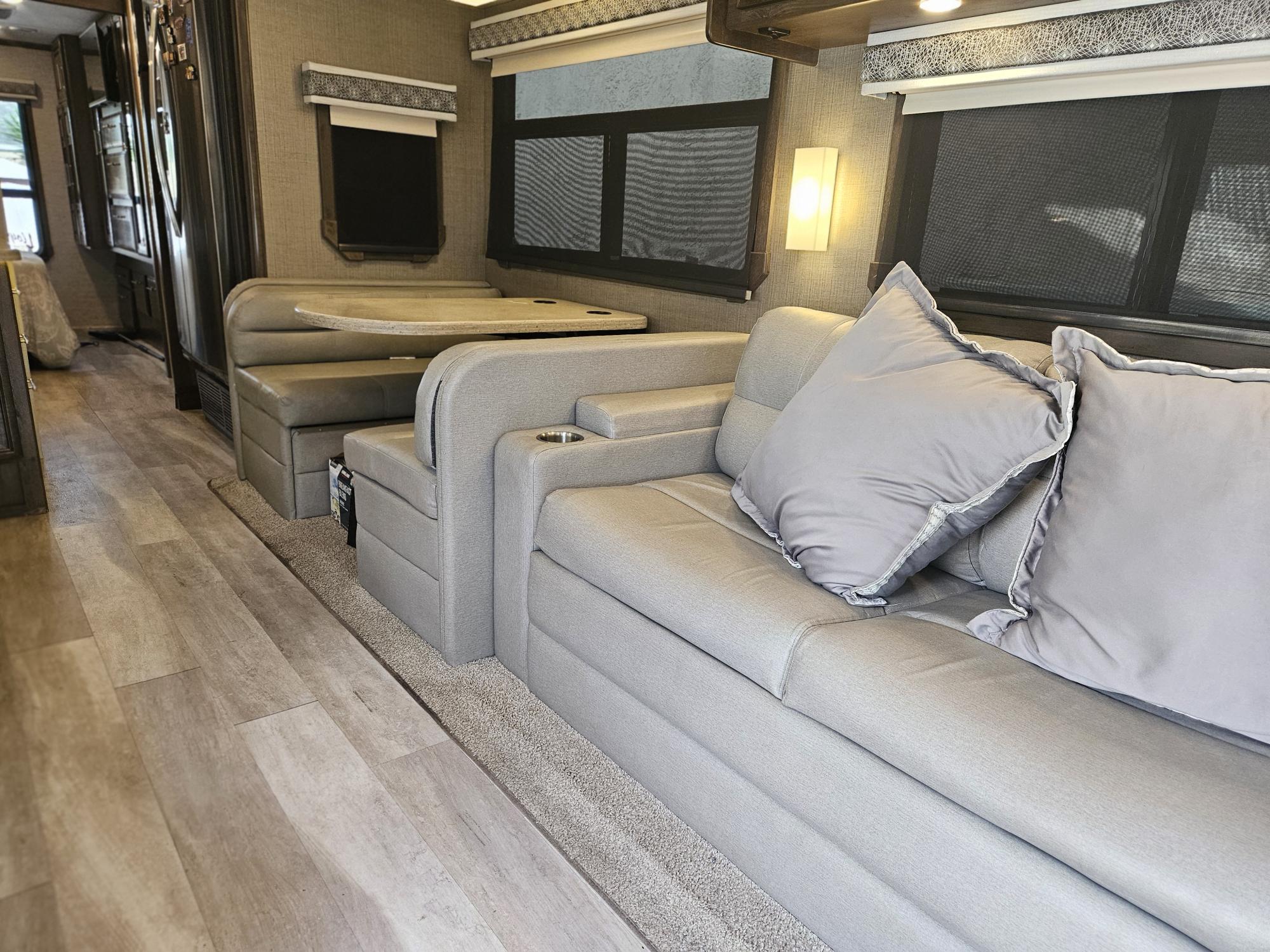 Sofa sleeper for 2 and table drops down to sleep additional friends. Entegra Coach Accolade XL 2021