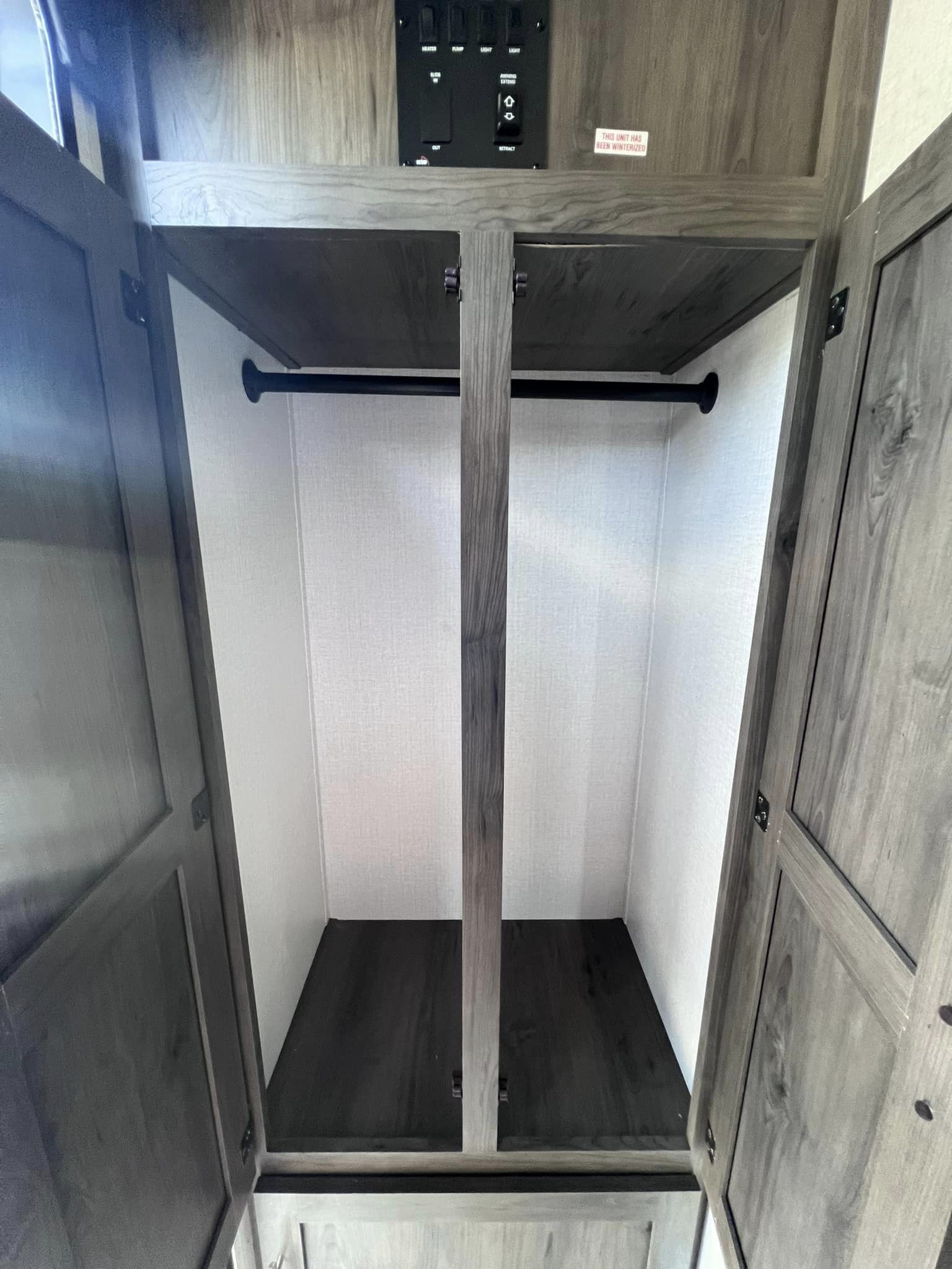 Explore this RV rental's spacious wardrobe, complete with a hanging bar and shelf, ready for your travel essentials.. Forest River Viking 2022