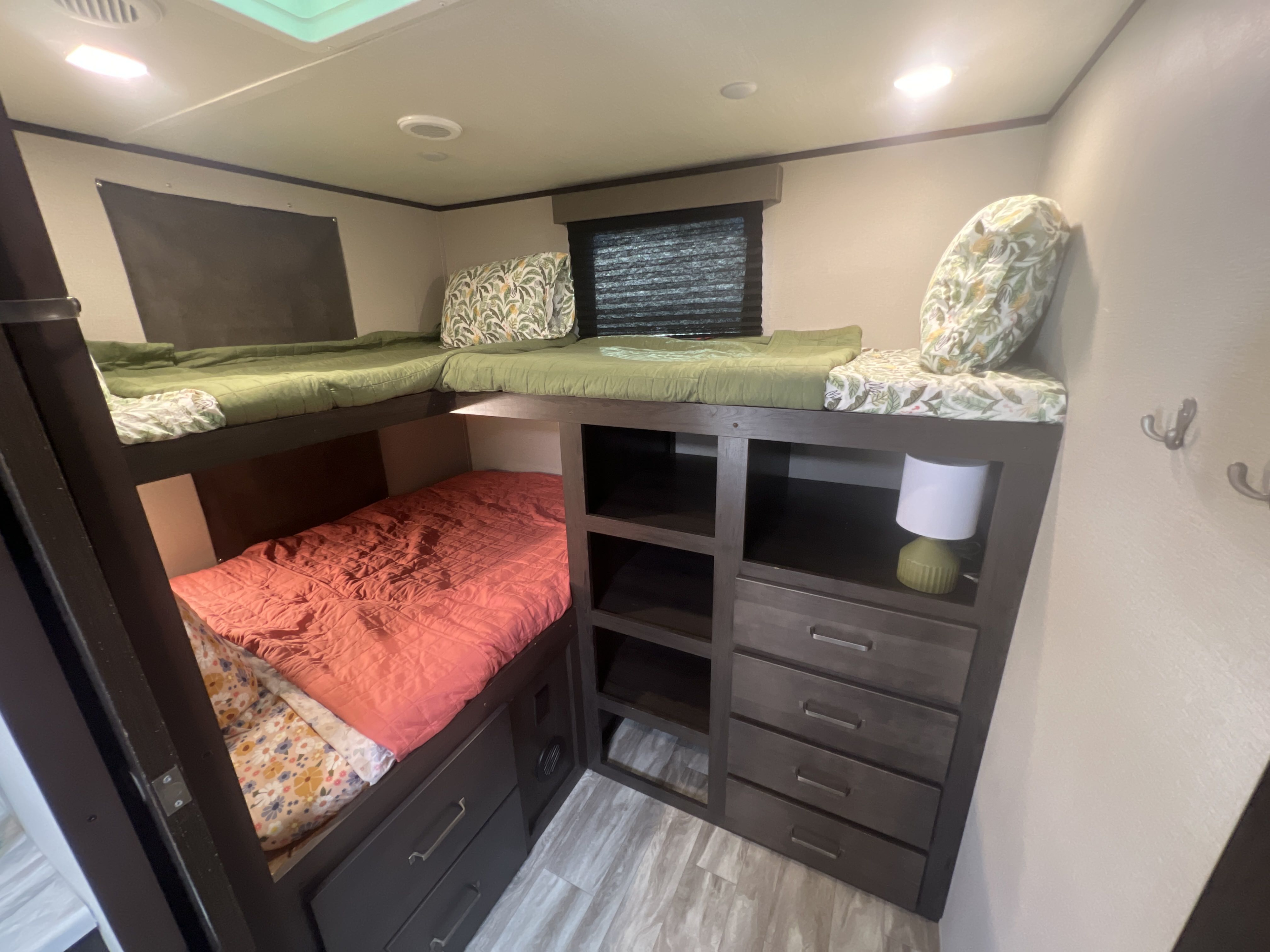 This RV rental features a multi-level bunk bed system with built-in storage, ideal for family trips.. Grand Design Transcend 2021