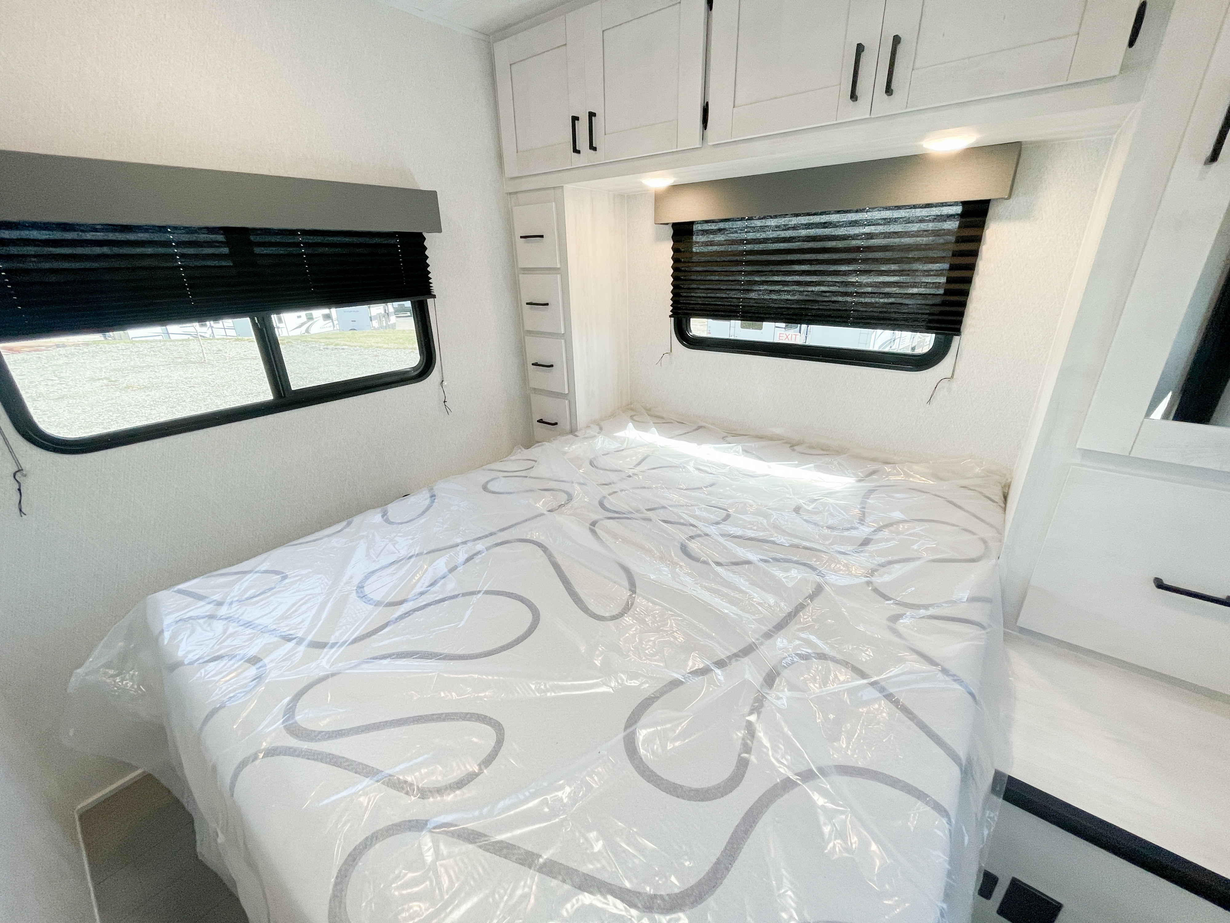 Queen bed with overhead storage. East to West Entrada 2025