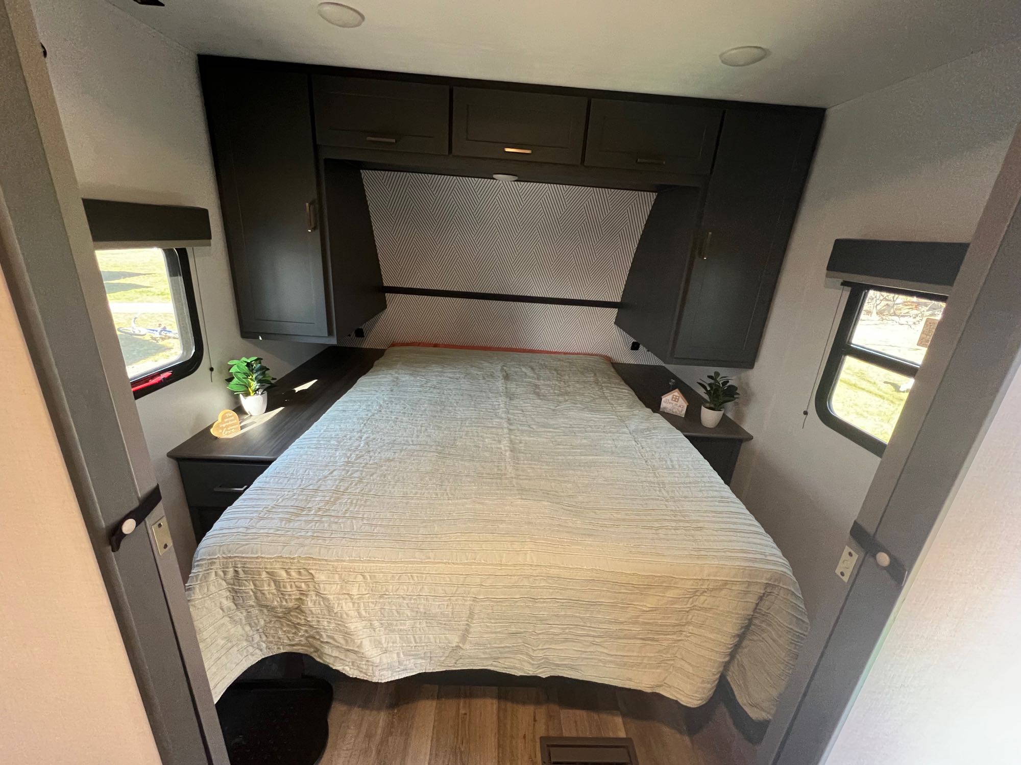 An inviting RV rental bedroom with a cozy bed, ample storage, and natural light from side windows.. Keystone Bullet Crossfire 4YDTBLN25RD430760 2024