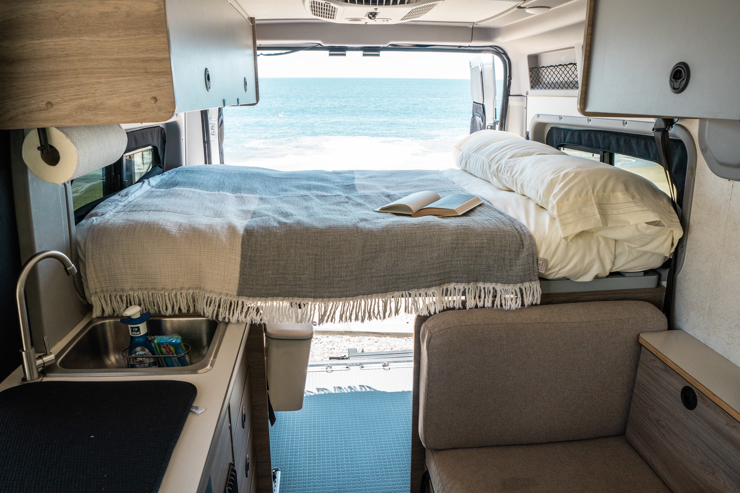 Experience the ultimate RV rental! This modern camper van offers a cozy bed, kitchenette, and breathtaking ocean views.. Winnebago Solis Pocket 2022