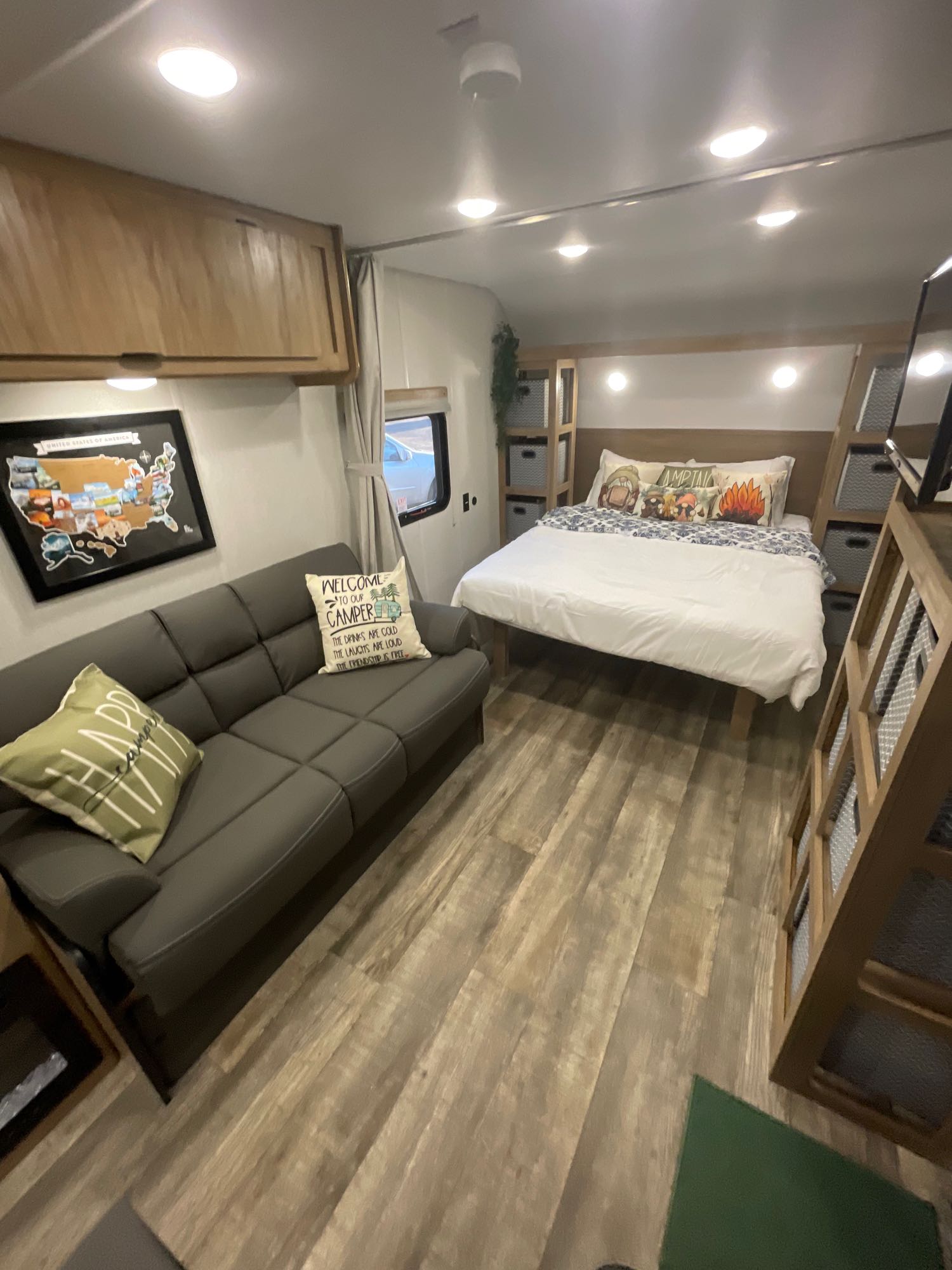 Step inside this inviting RV rental. A comfortable futon, cozy bed, and charming camper decor fill the living space, perfect for travel.. Forest River Cherokee Wolf Den 26EV 2024