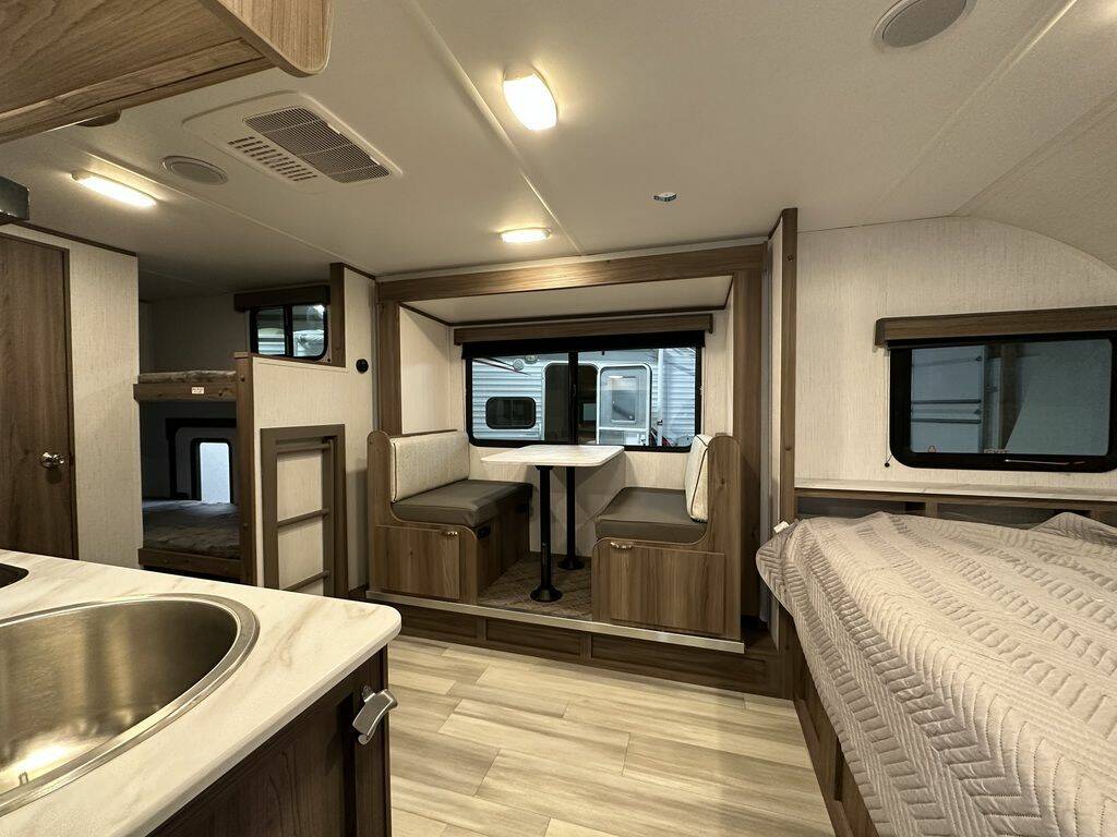 This RV rental shows a full interior: kitchen, dinette, bunk beds, and main bed, providing comfortable living space.. Cruiser RV Hitch 2024