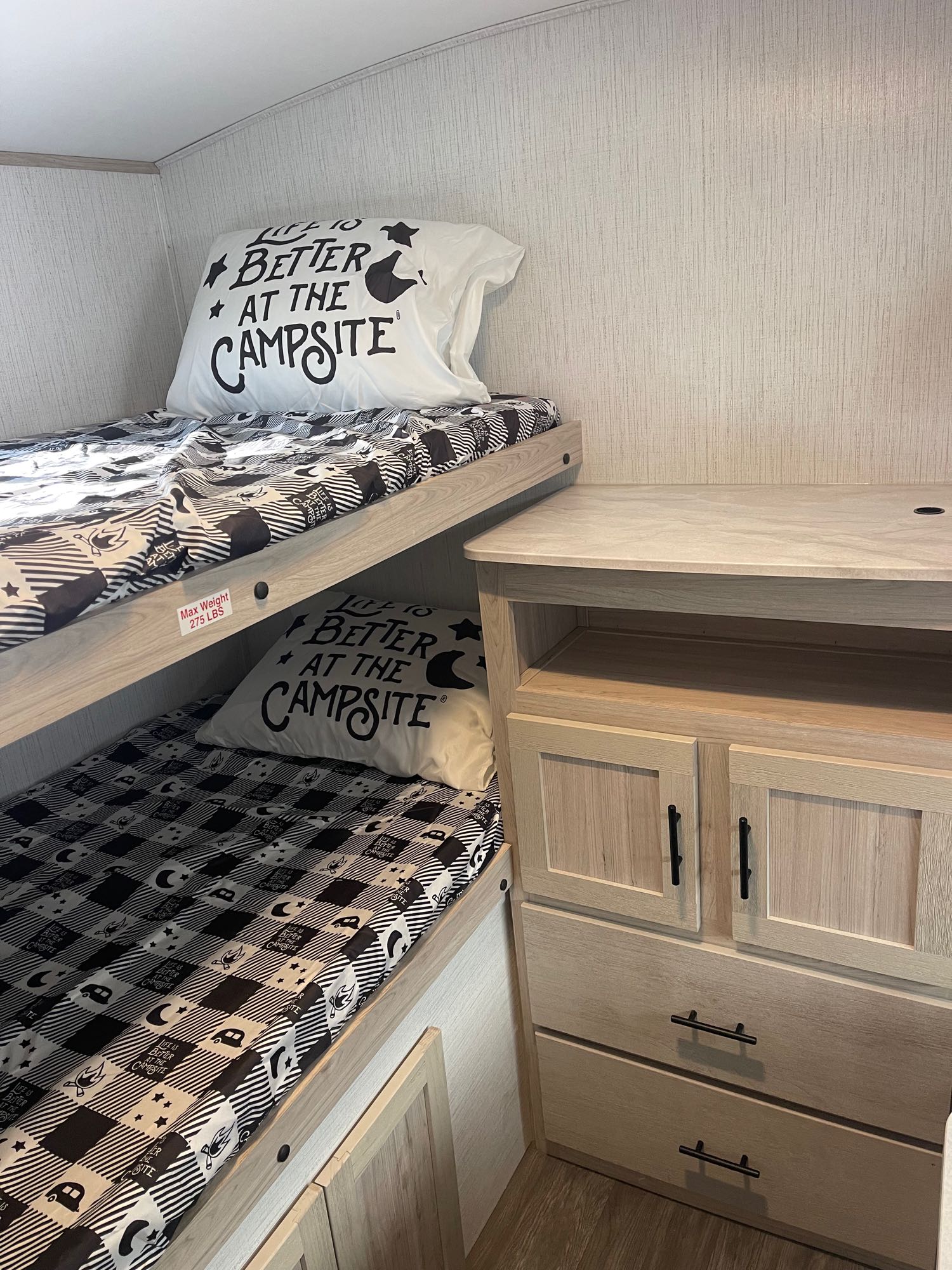 Cozy RV rental bunk beds featuring "Life is Better at the Campsite" bedding and convenient storage.. Cruiser RV Shadow Cruiser 2023