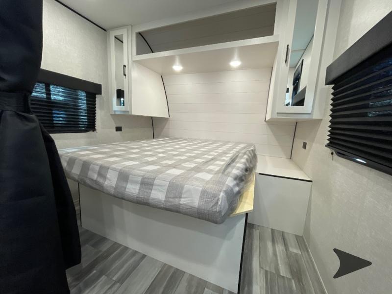 Modern RV rental bedroom featuring a comfortable bed, overhead storage, and blinds for privacy.. Jayco Jay Flight 2024