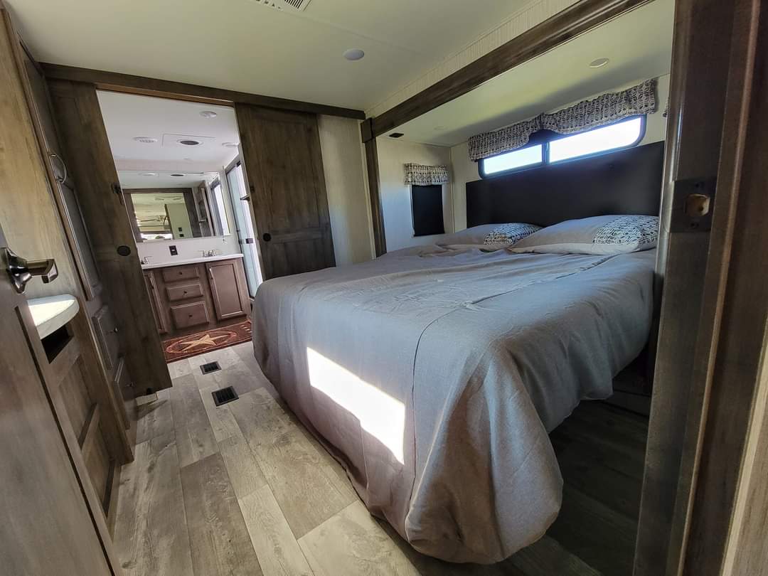 Explore this spacious RV rental featuring a cozy bedroom & attached bath with modern finishes.. Forest River Sierra 2022