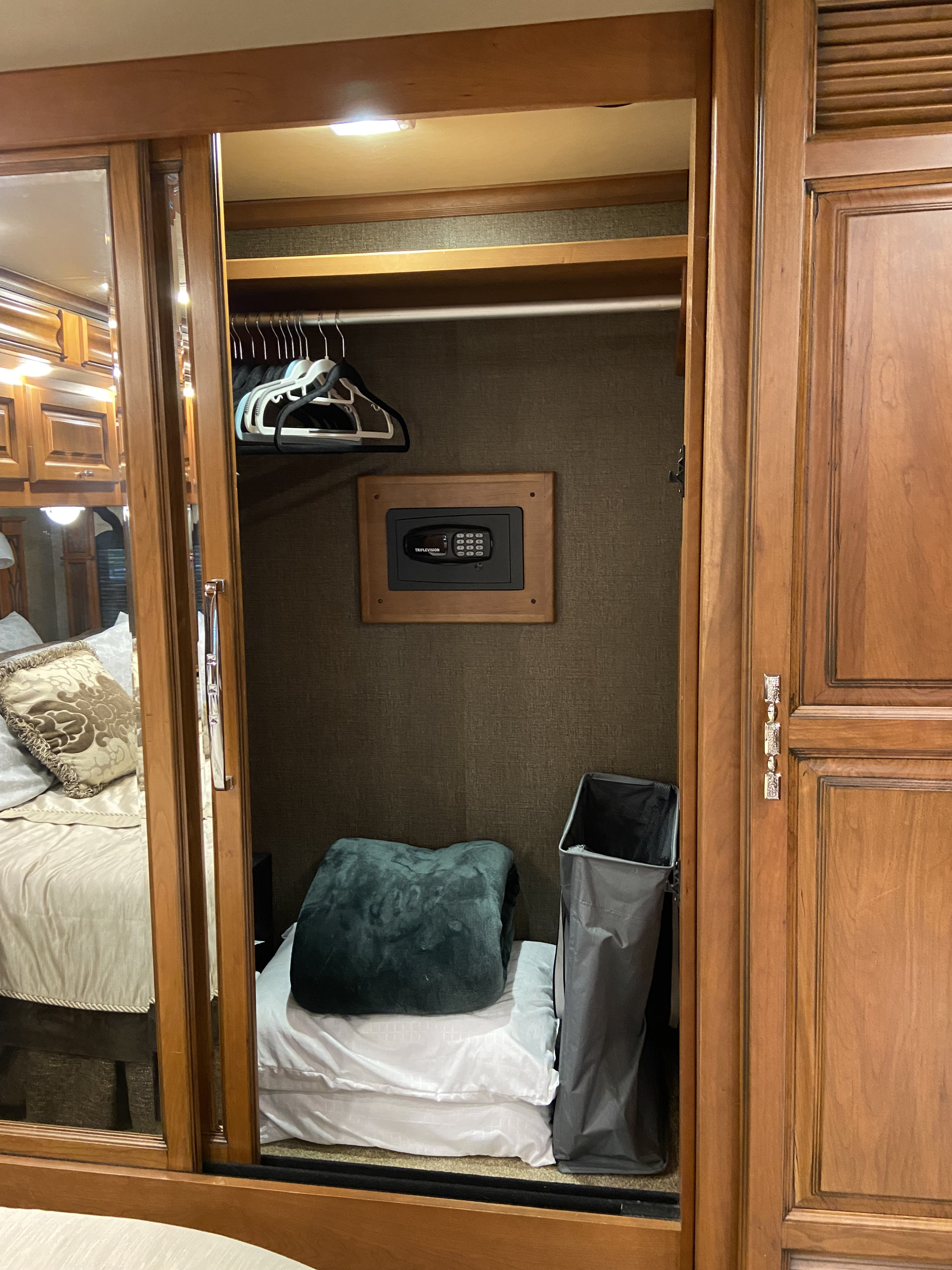 An **RV rental** bedroom closet with a secure built-in safe, hanging rod, and storage for your travel essentials.. Tiffin Motorhomes Allegro Bus 2017