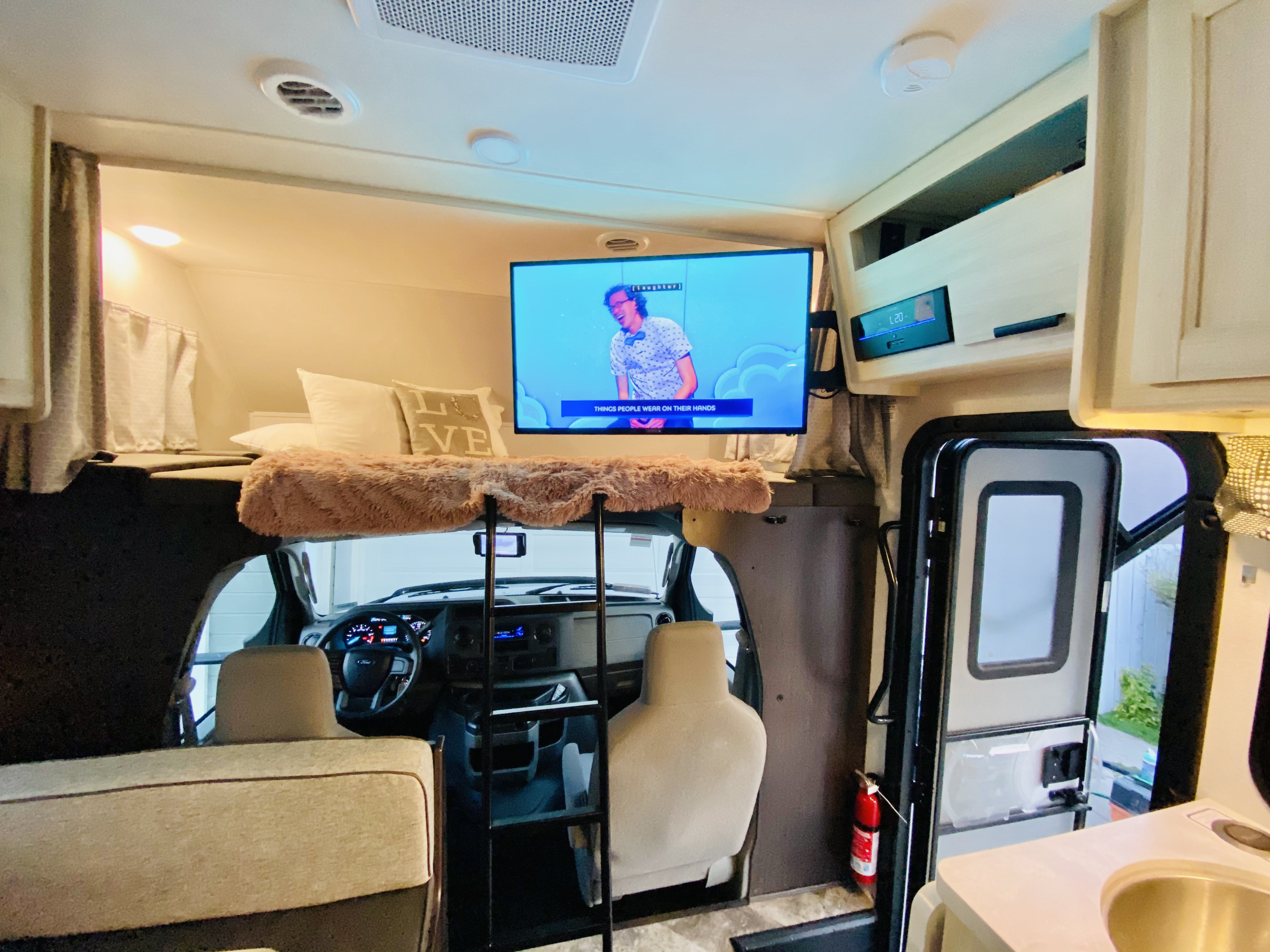 Step inside this RV rental! Features a comfortable cab-over bed with TV, kitchen area, and front cockpit access.. Forester LE 2021