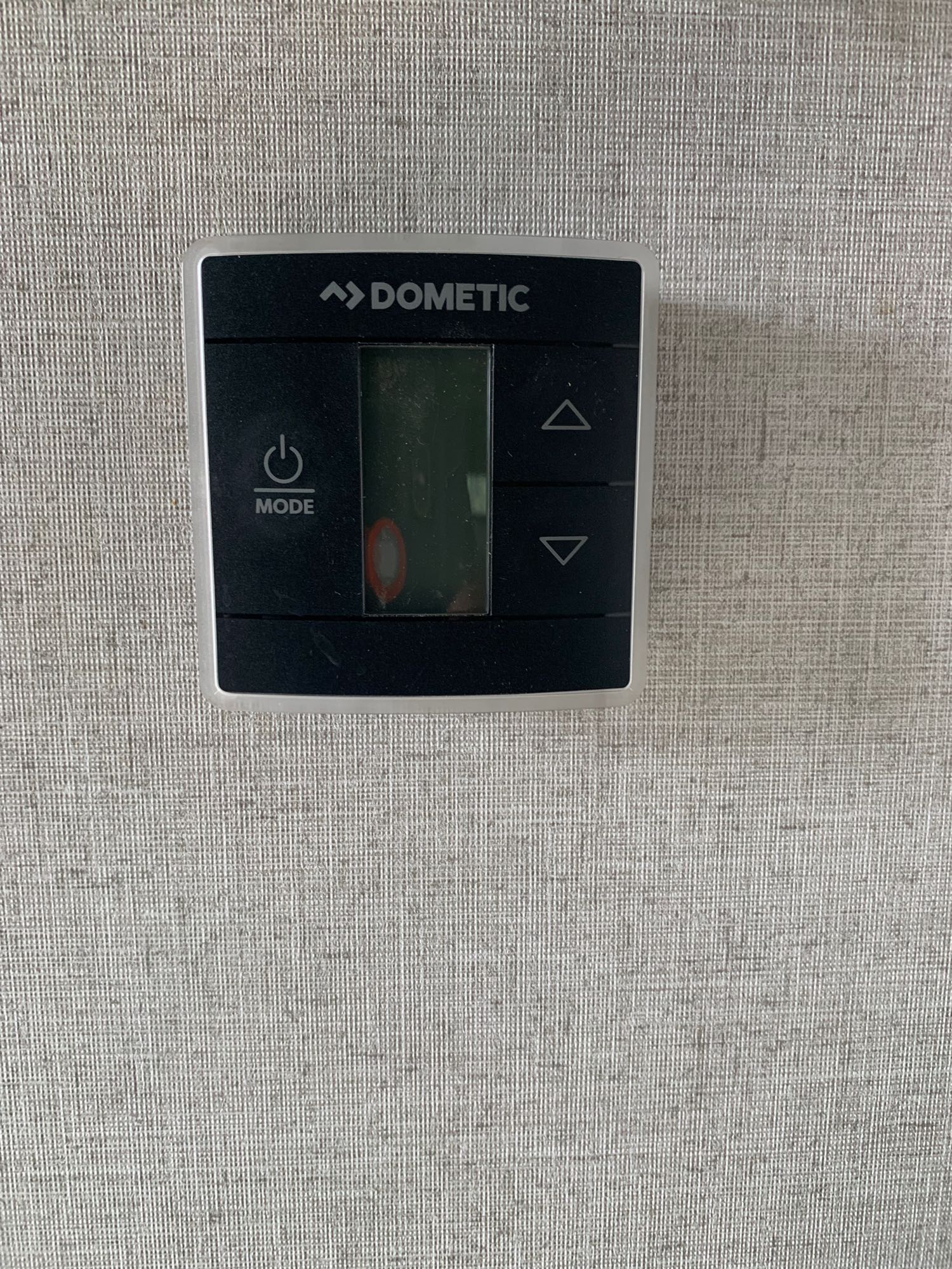Close-up of a Dometic RV thermostat control panel, essential for HVAC comfort in your rv rental.. Highland Ridge RV Open Range 2020