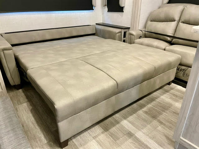 This RV rental features a comfortable, light-colored sofa bed within its spacious living area.. Tandara East To West 2022