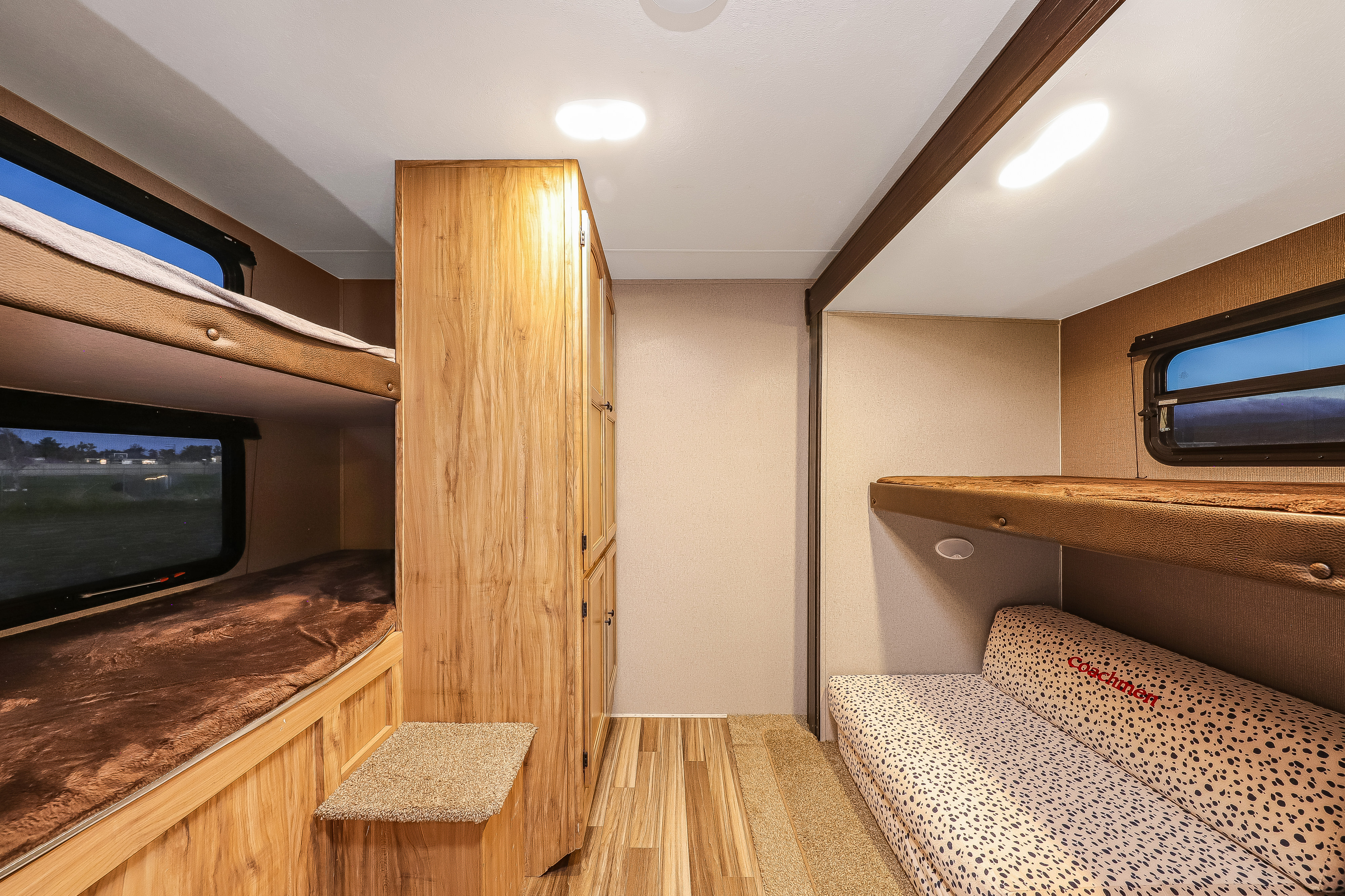 RV rental bunk room: features stacked bunks, a sofa bed with overhead bunk, and built-in storage. Ideal for family travel.. Coachmen Freedom Express Select 31SE 2018