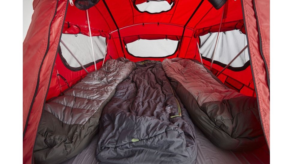 Inside a red camping tent, three sleeping bags lie ready. Perfect extra sleeping for your next RV rental trip.. Kia Sportage 2011