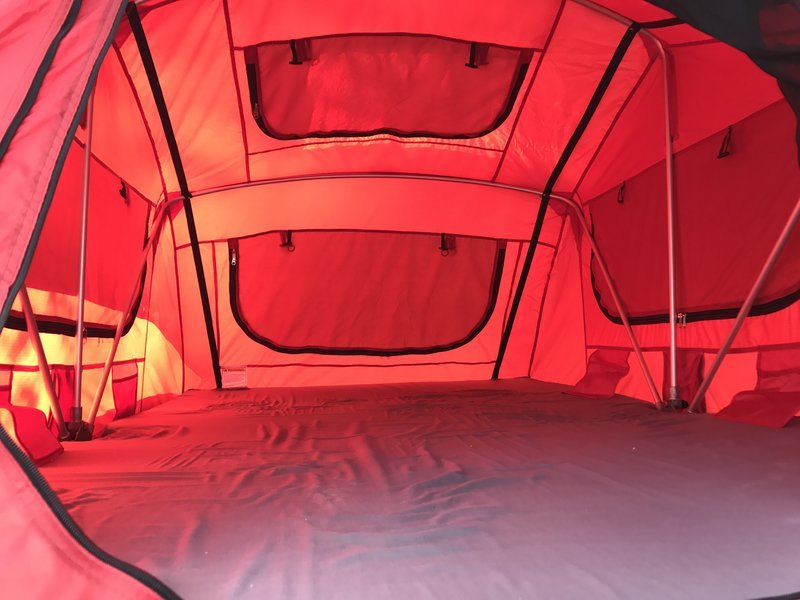 Experience comfortable rv rental adventures! This spacious red rooftop tent interior offers a cozy sleeping space for camping trips.. Kia Sportage 2011