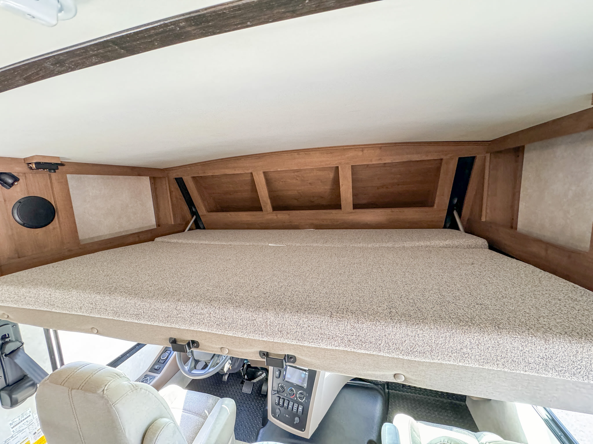 View inside an RV rental showing the cab-over bunk bed above the driver's area, ideal for extra sleeping space.. Forest River Fr3 2021