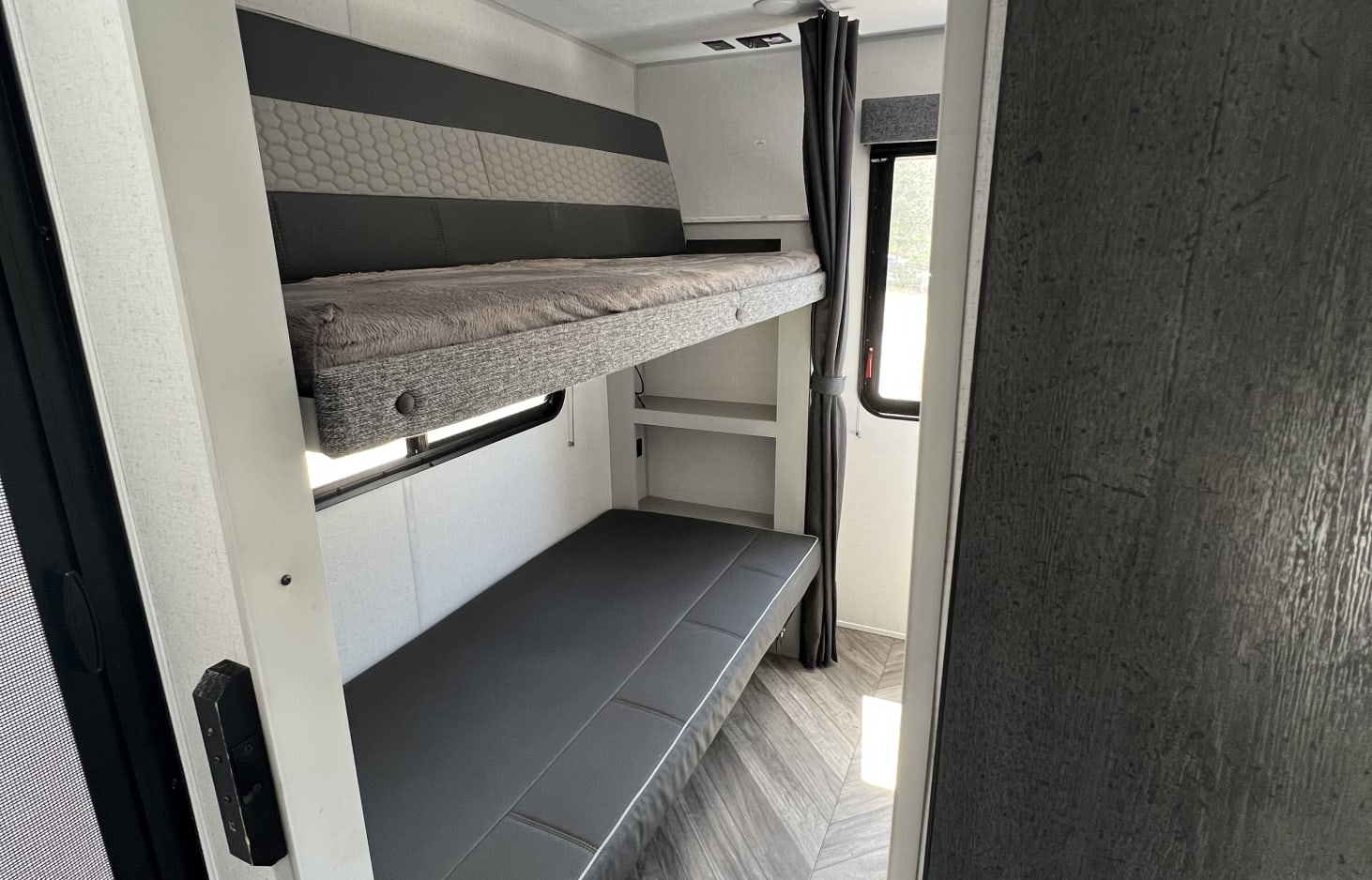 RV rental: Bright bunk bed area with an upper bed and a lower convertible bench, ideal for family sleeping in a camper.. Forest River Salem FSX 2022