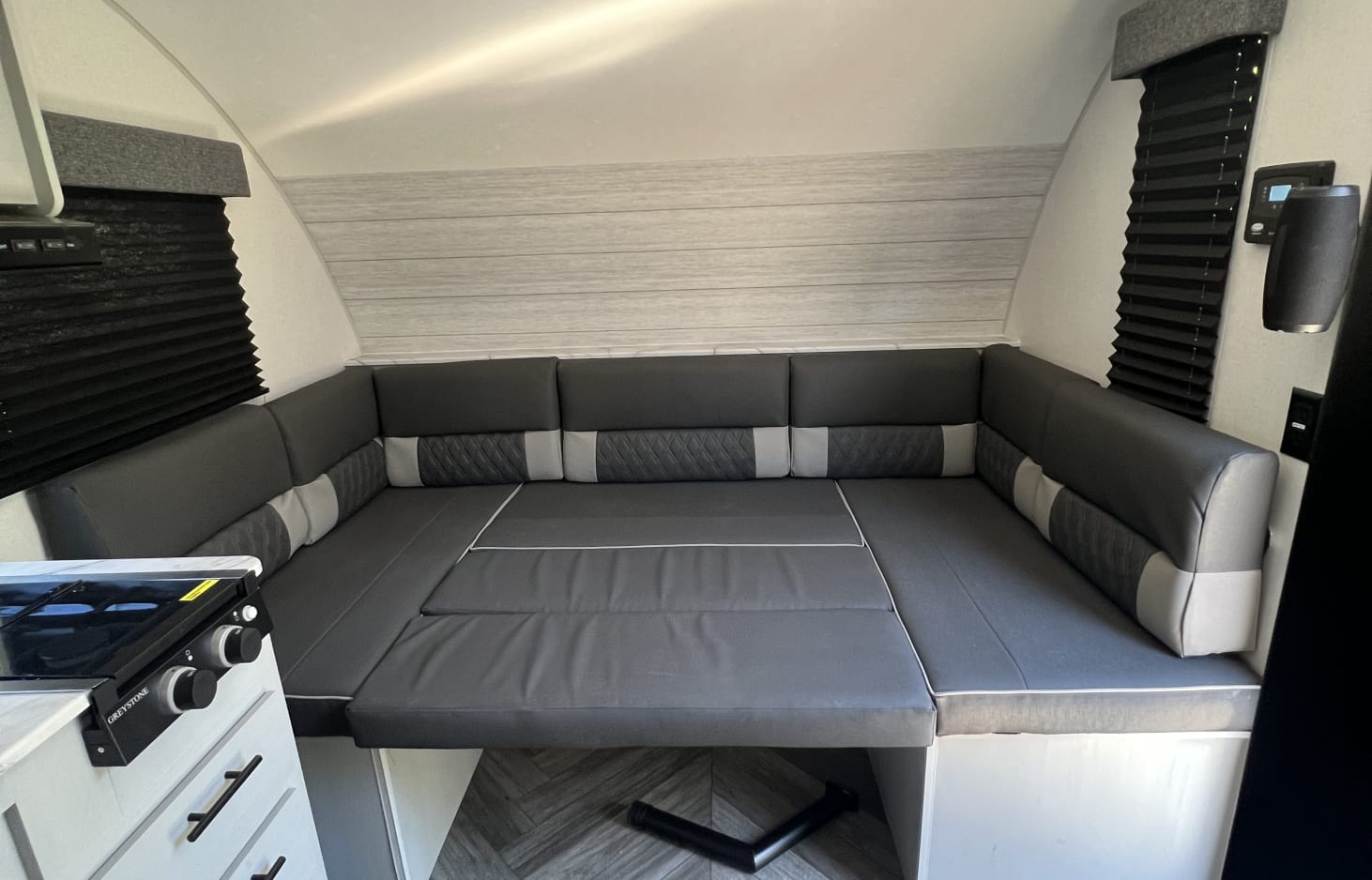 This RV rental's clever interior features a grey U-shaped dinette that converts to a comfortable bed.. Forest River Salem FSX 2022