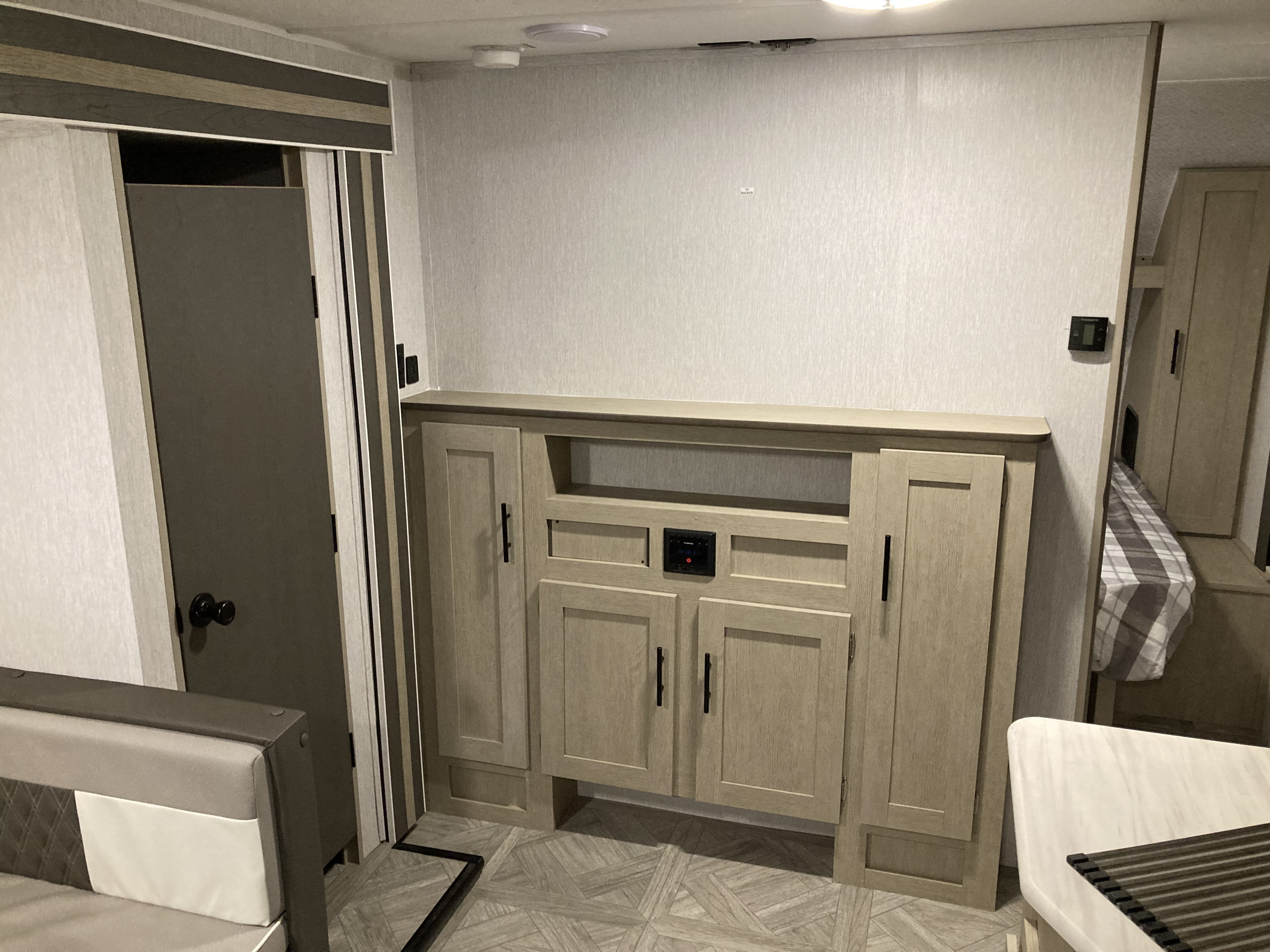 RV rental interior features modern light wood cabinetry with TV backer, stereo, dinette, and a cozy sleeping area.. Forest River Salem Cruise Lite 2023