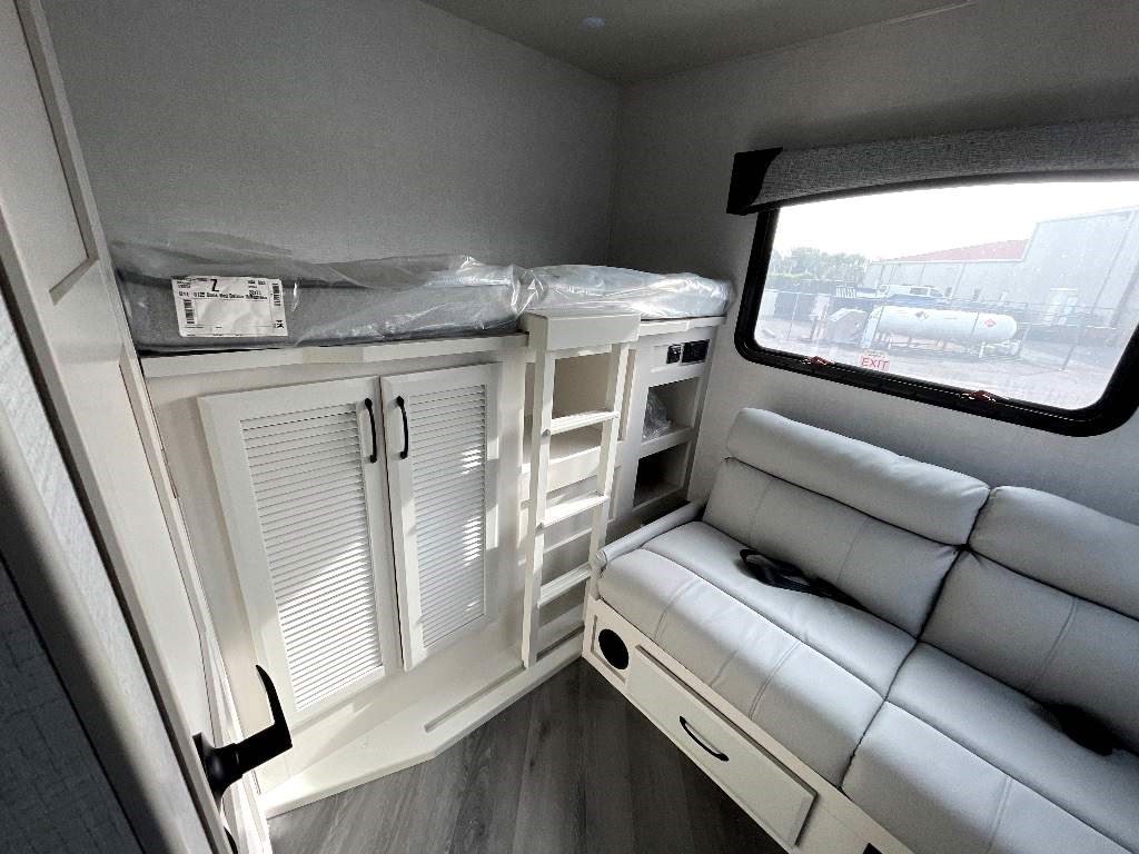 Modern RV rental features: cozy bunk bed, comfortable sofa, and smart storage solutions for your trip.. Fleetwood Fortis 2024