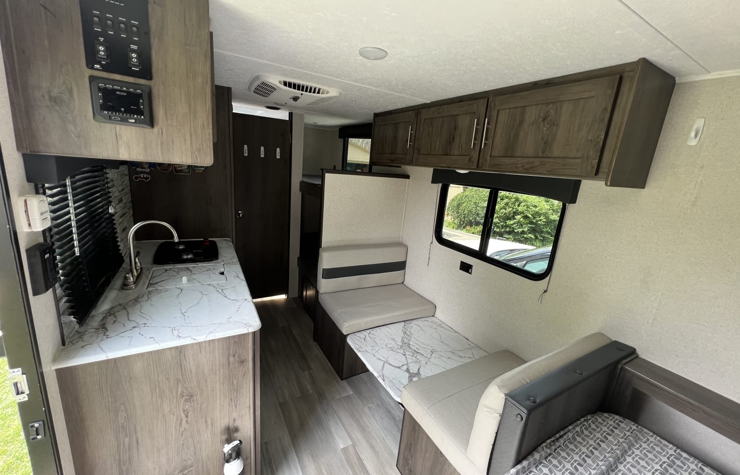 Inside this **rv rental**: a functional kitchen with sink, controls, and a comfortable dinette. Bright, modern interior for your trip.. Clipper Ultra Lite 2022