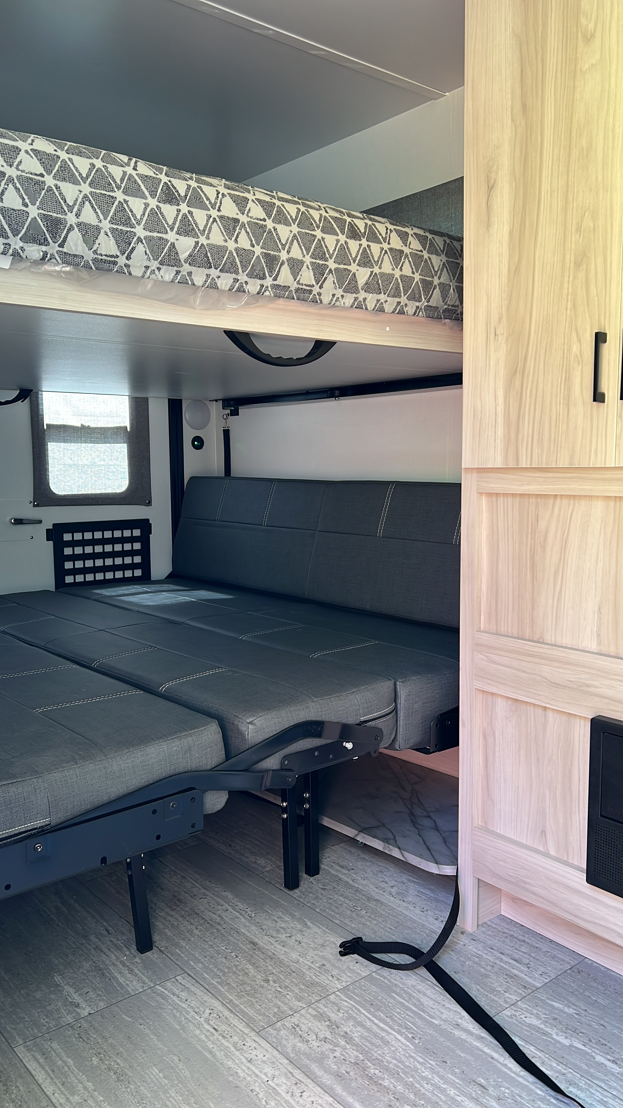 This RV rental features a flexible interior with a top bunk and a lower sofa that converts into a bed.. Winnebago Hike 100 2023