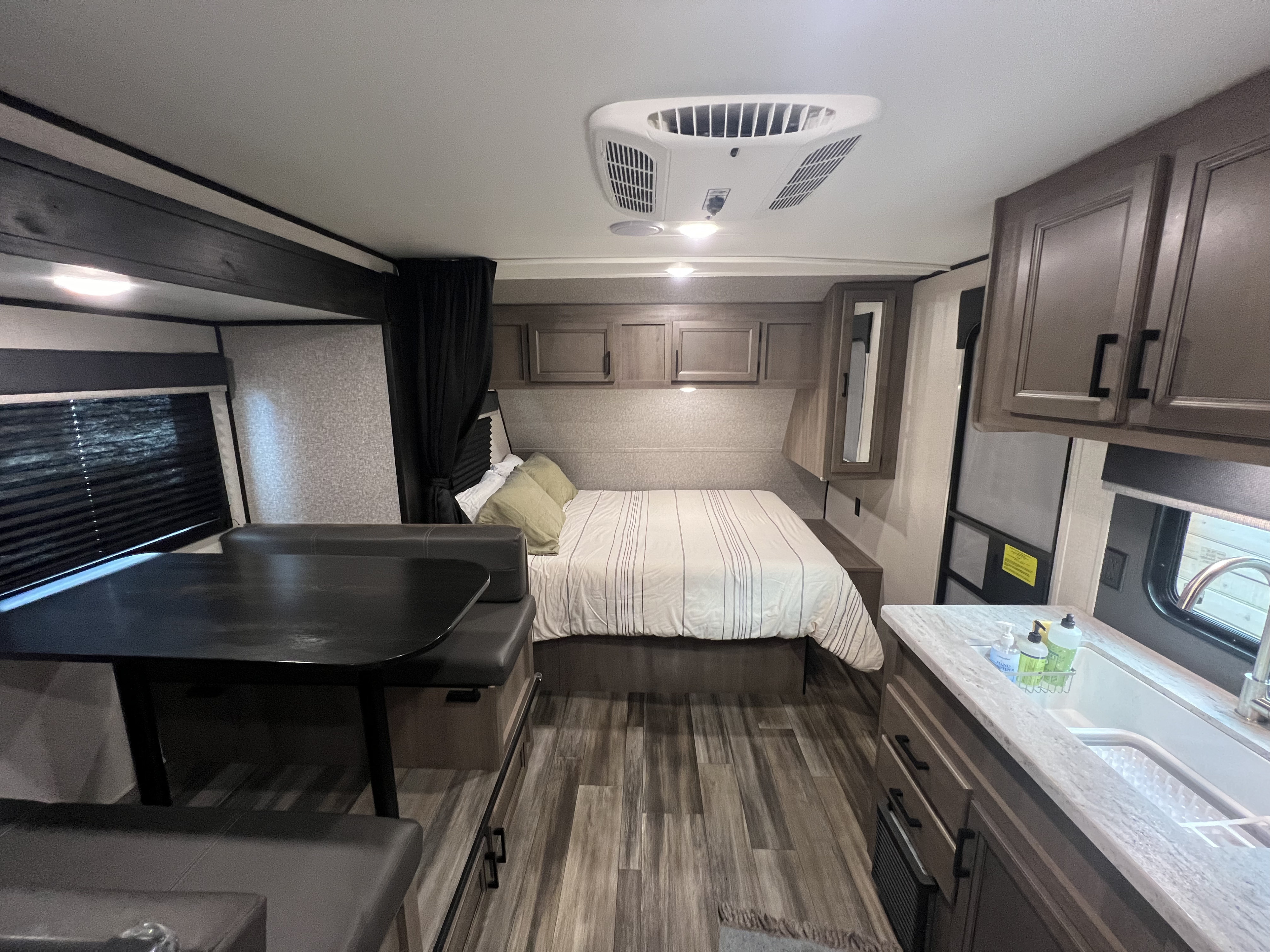 Spacious RV rental interior with bedroom, dining, and kitchen areas, perfect for travel adventures.. Starcraft Autumn Ridge 2022