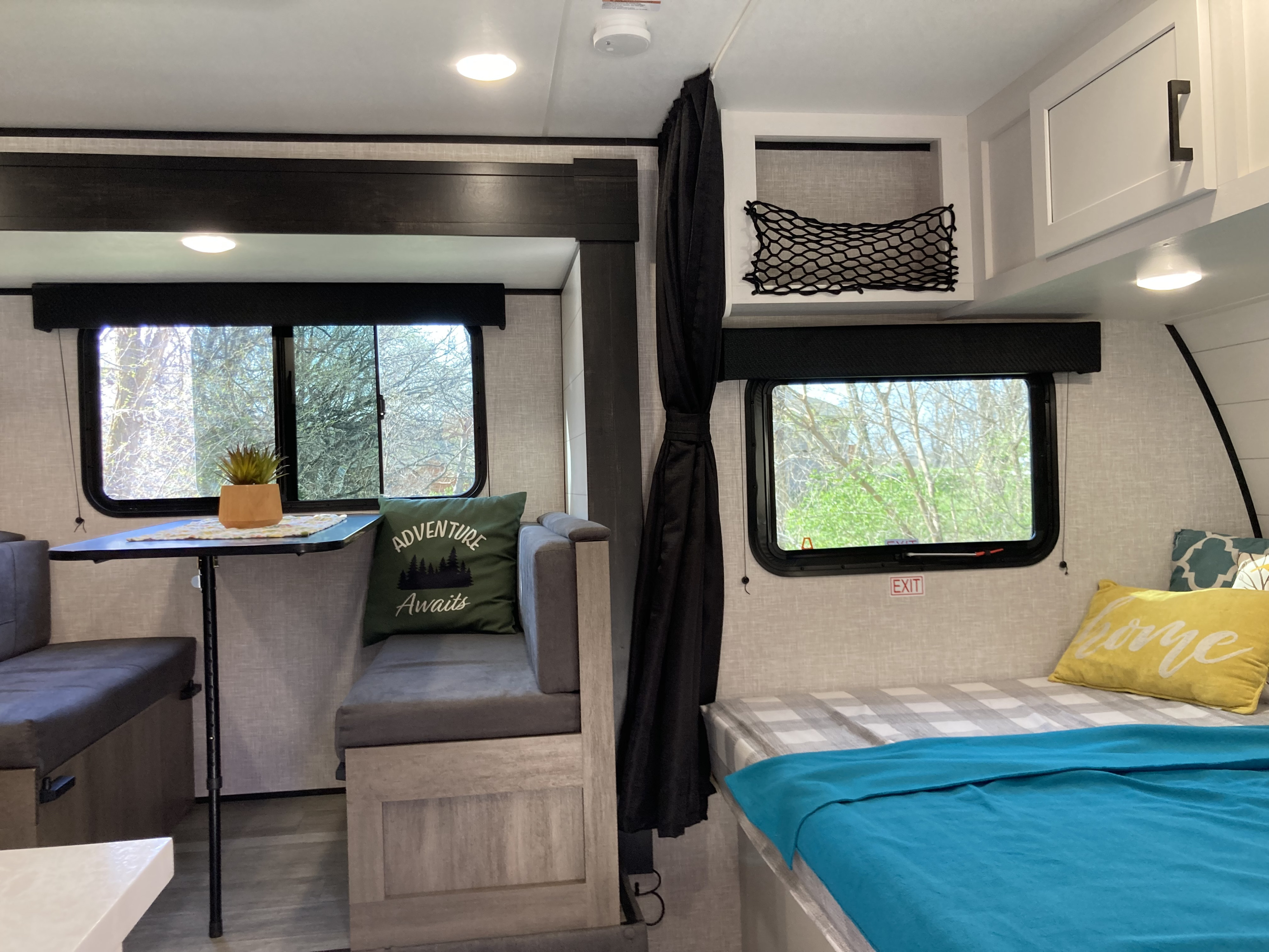 Cozy RV rental interior with dinette, bed, and storage. Perfect for travel adventures.. Jayco Jay flight 184bs 2024