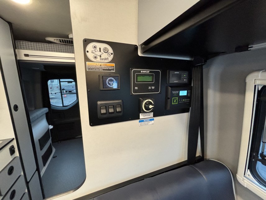 RV rental interior: A detailed smart control panel manages power, solar, and Euroloft bunk operation in a modern camper van.. Winnebago Revel 2024