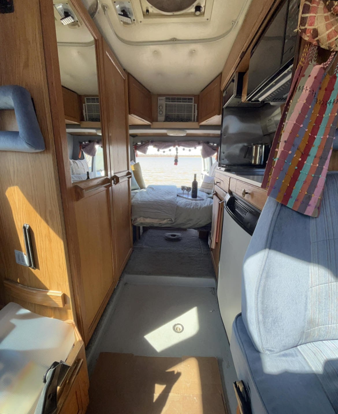 Step inside this charming RV rental! Features a comfy bed, kitchen, & scenic water view for your next escape.. Roadtrek 190 Versatile 1995