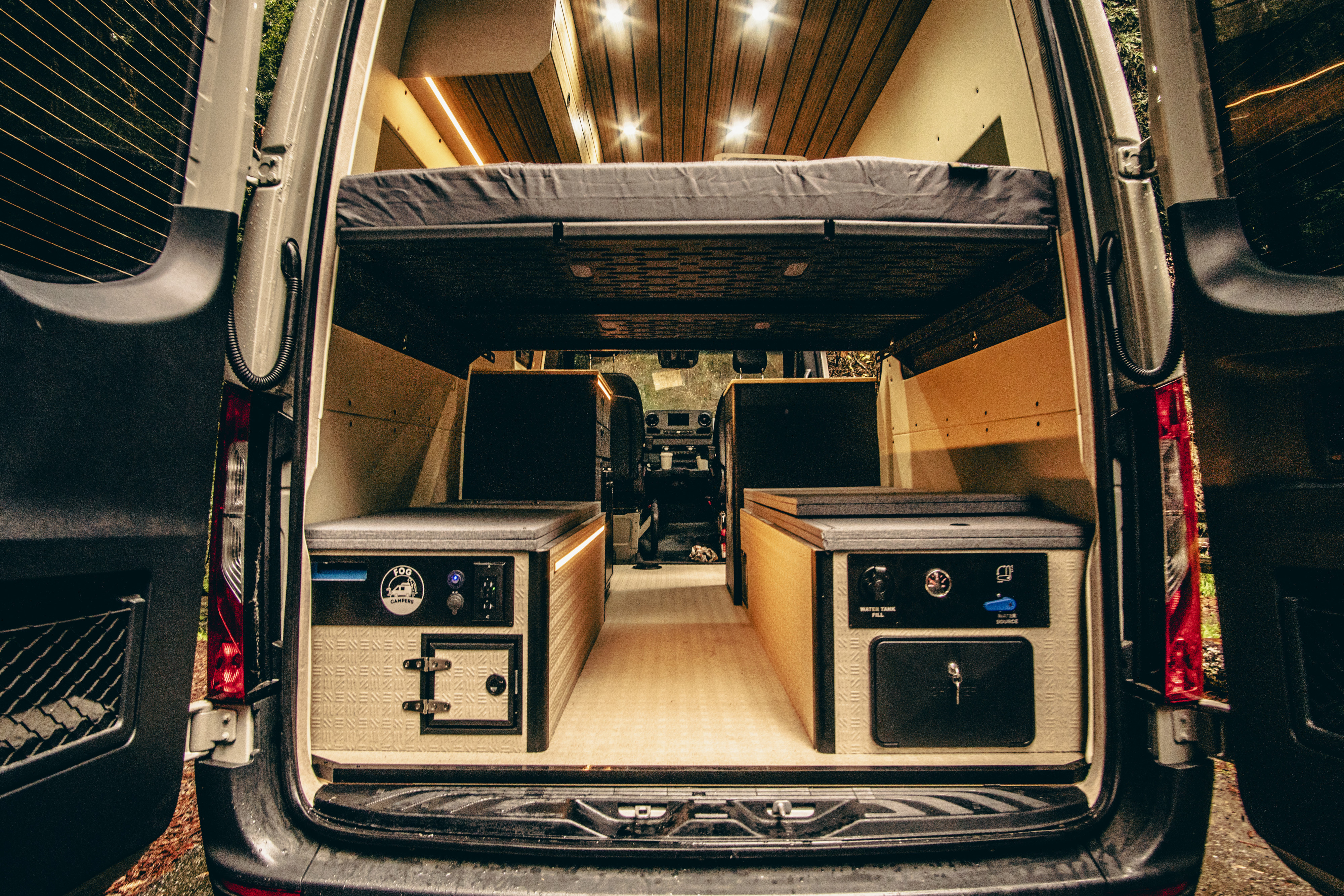 Experience a functional RV rental. This custom camper van showcases an elevated bed, integrated water system & clever storage.. Mercedes-Benz Sprinter 2023