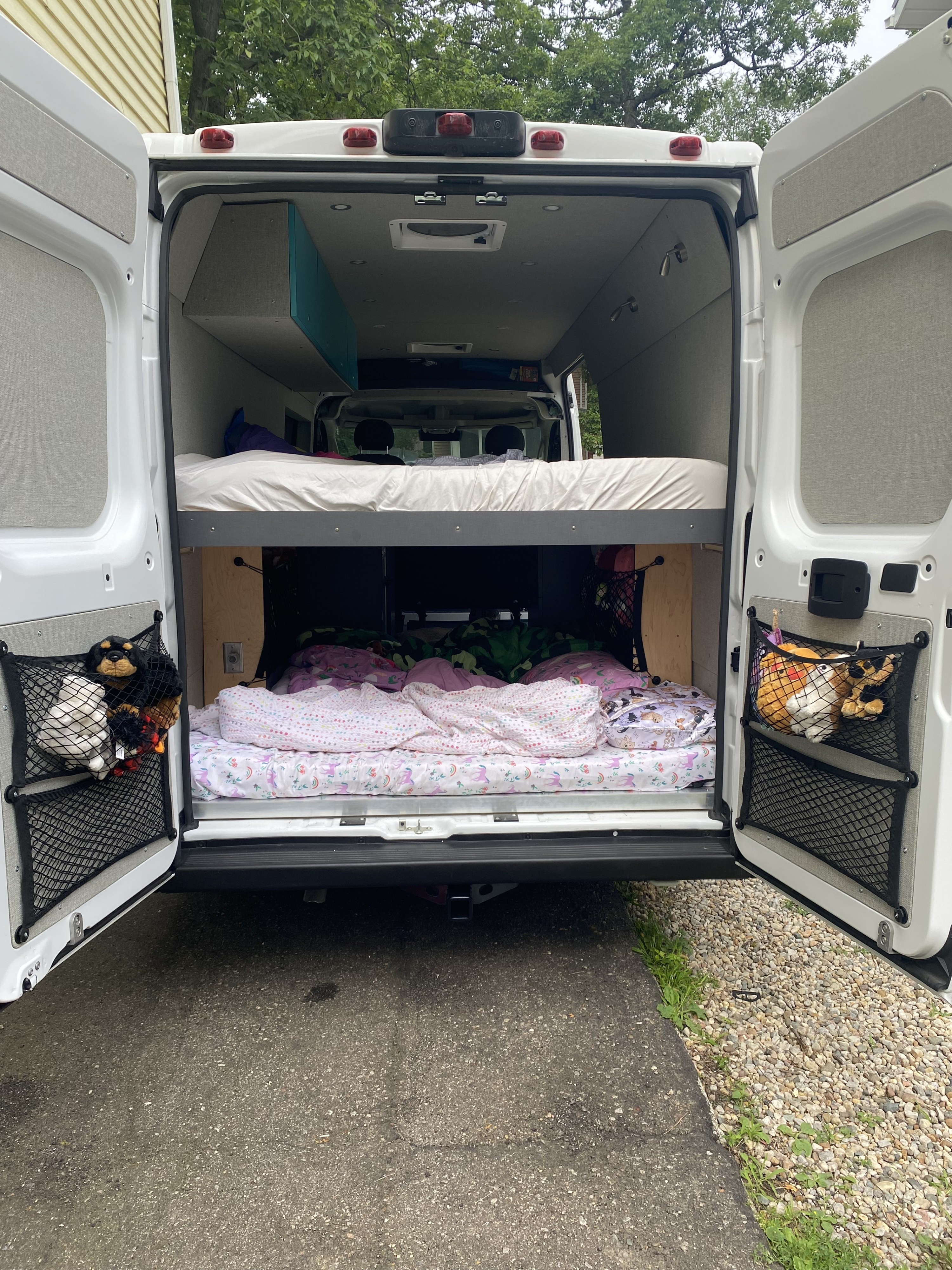 RV rental interior featuring bunk beds & clever storage, perfect for family adventures on the road.. RAM ProMaster 2023