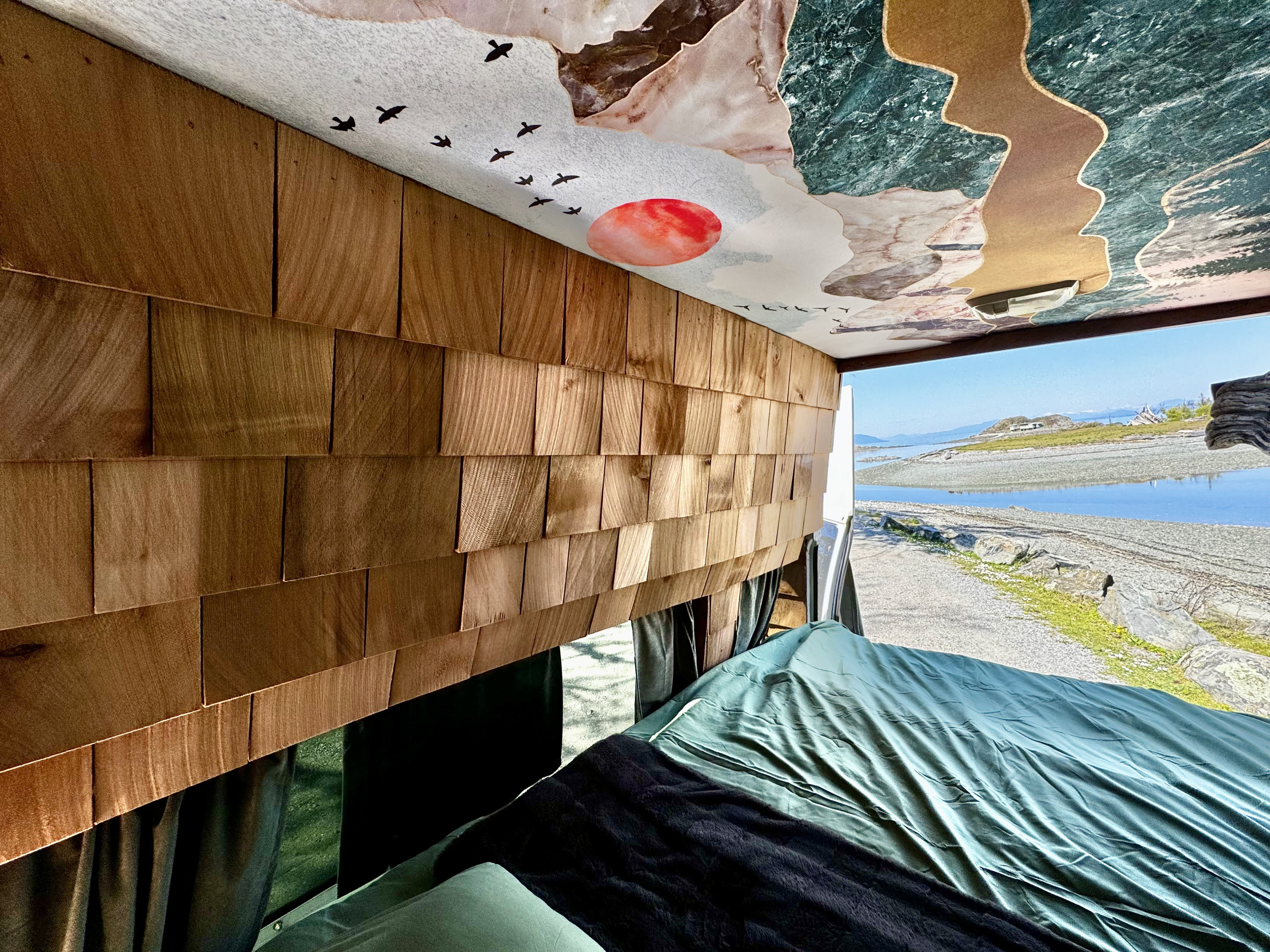 Inside a unique RV rental, enjoy custom wood shingle walls & a mountain-mural ceiling. Wake up to a scenic lake view!. Ford Econoline E250supercab 2001