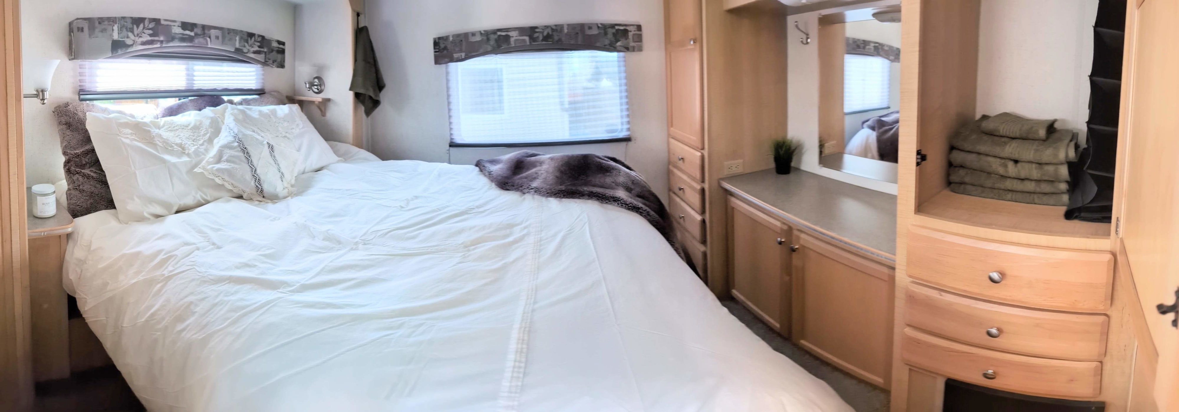 Cozy RV rental bedroom with a comfortable bed, windows, and built-in storage. Perfect for your travels.. R-Vision Trail-Lite 2004