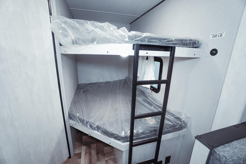 RV rental: Bright bunk beds, upper rated 250 LB, with protected mattresses and a ladder.. Gulf Stream Grand River 2023