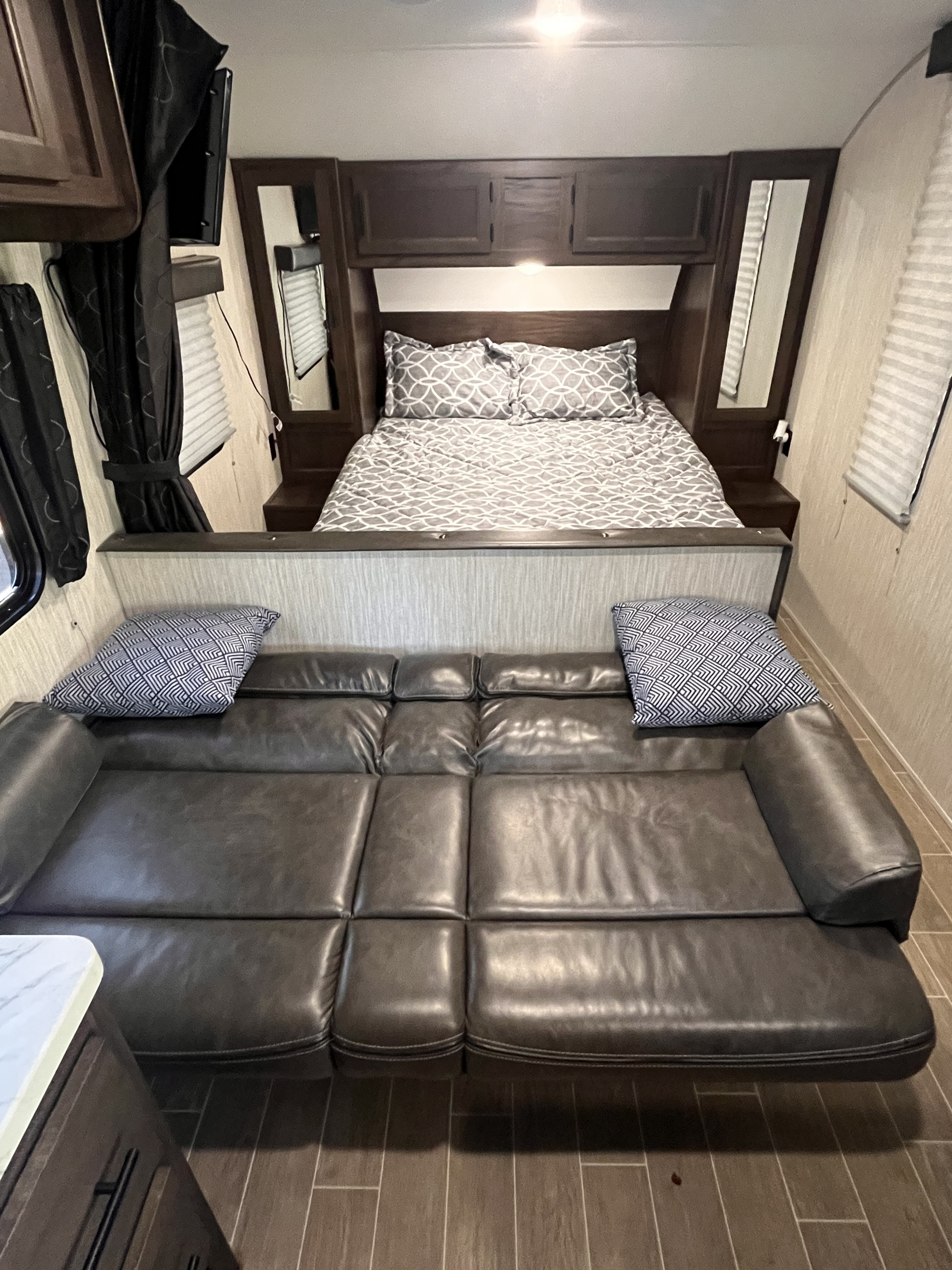 RV rental: Cozy camper interior featuring a comfortable bed, reclining sofa, and windows with blinds.. Forest River Cherokee Grey Wolf Special Edition 2020