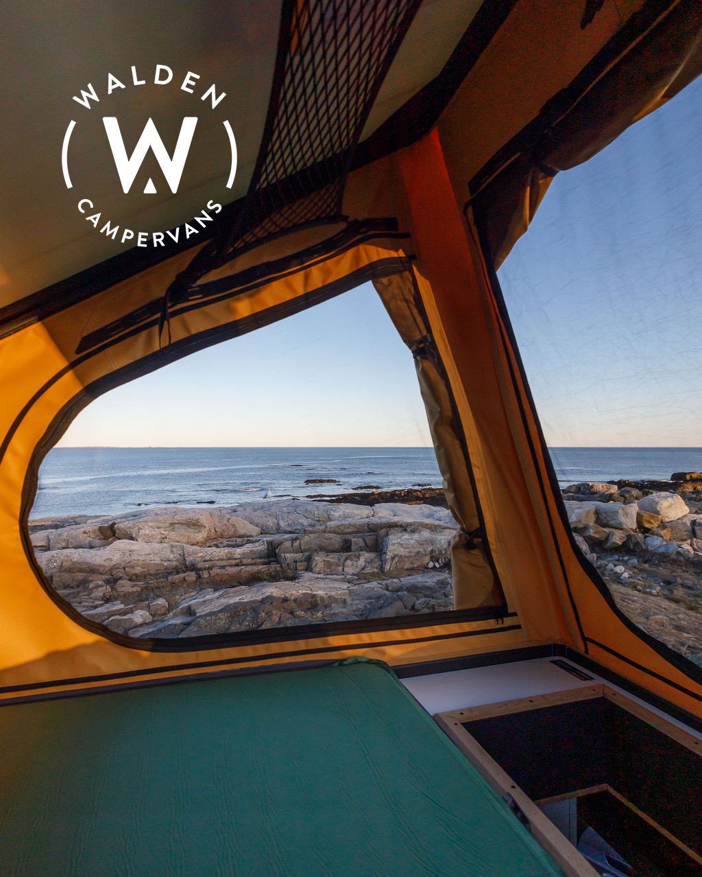 Coastal adventure awaits! View from an RV rental's cozy interior: green mattress, rocky ocean shore, and endless sea.. Mercedes-Benz Sprinter 2023