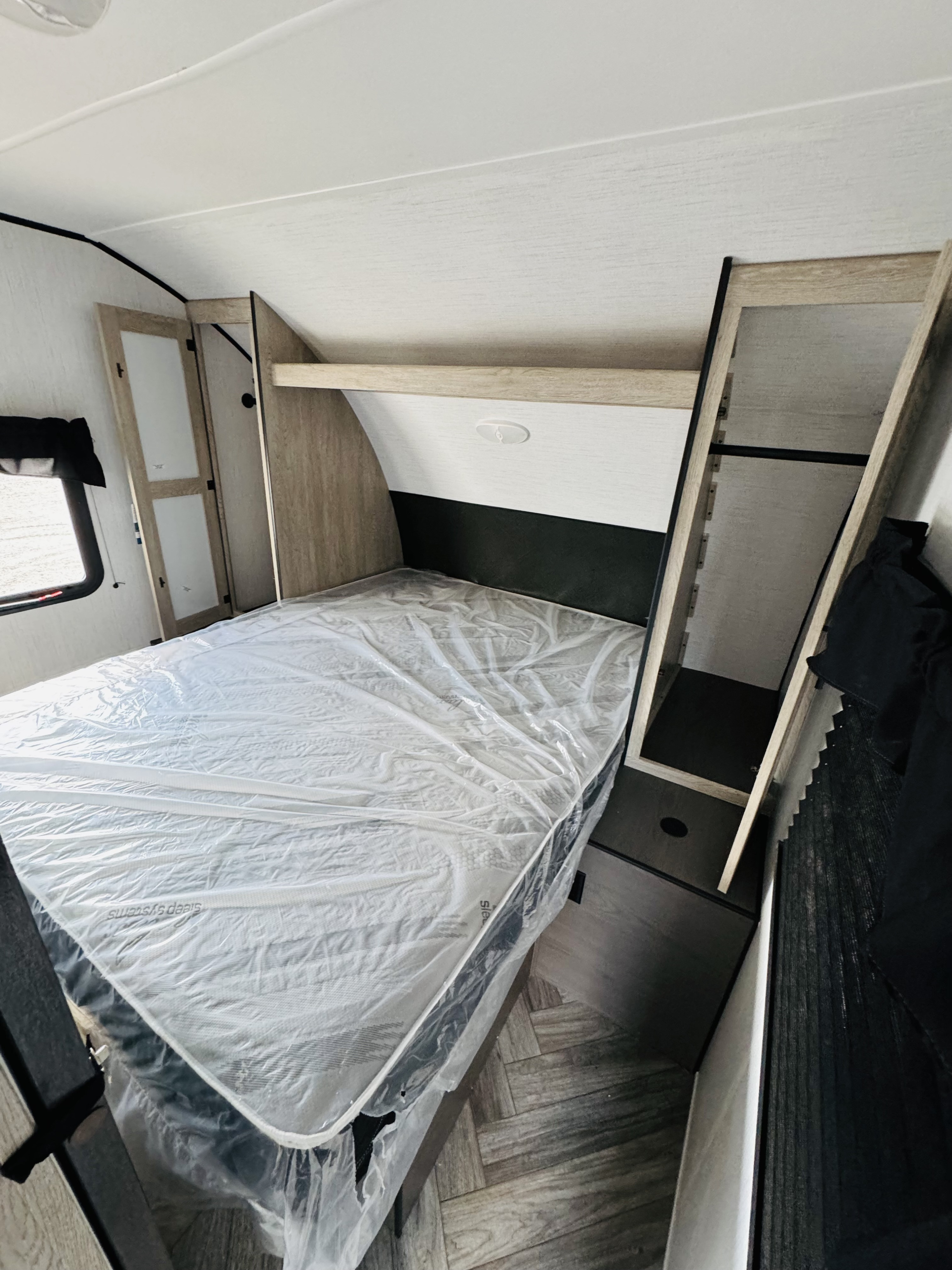Explore this cozy rv rental bedroom: new mattress, ample built-in storage, and a handy closet.. Heartland RVs Prowler 2024