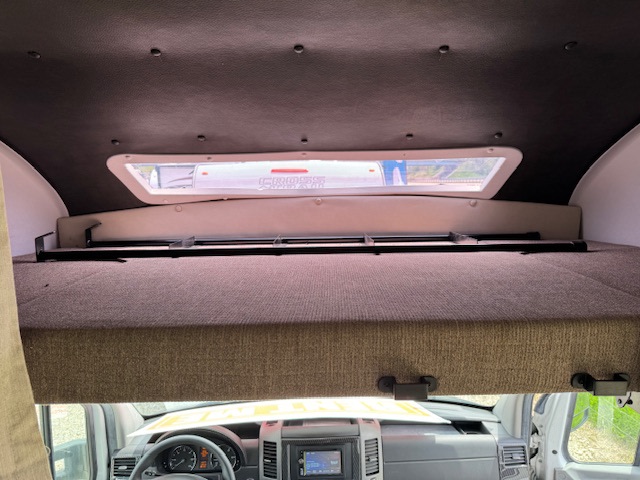 Inside an RV rental: a spacious cab-over bunk bed above the driver's cabin. Ideal for a campervan sleeping area.. Forest River Coachmen Prism Elite 2020