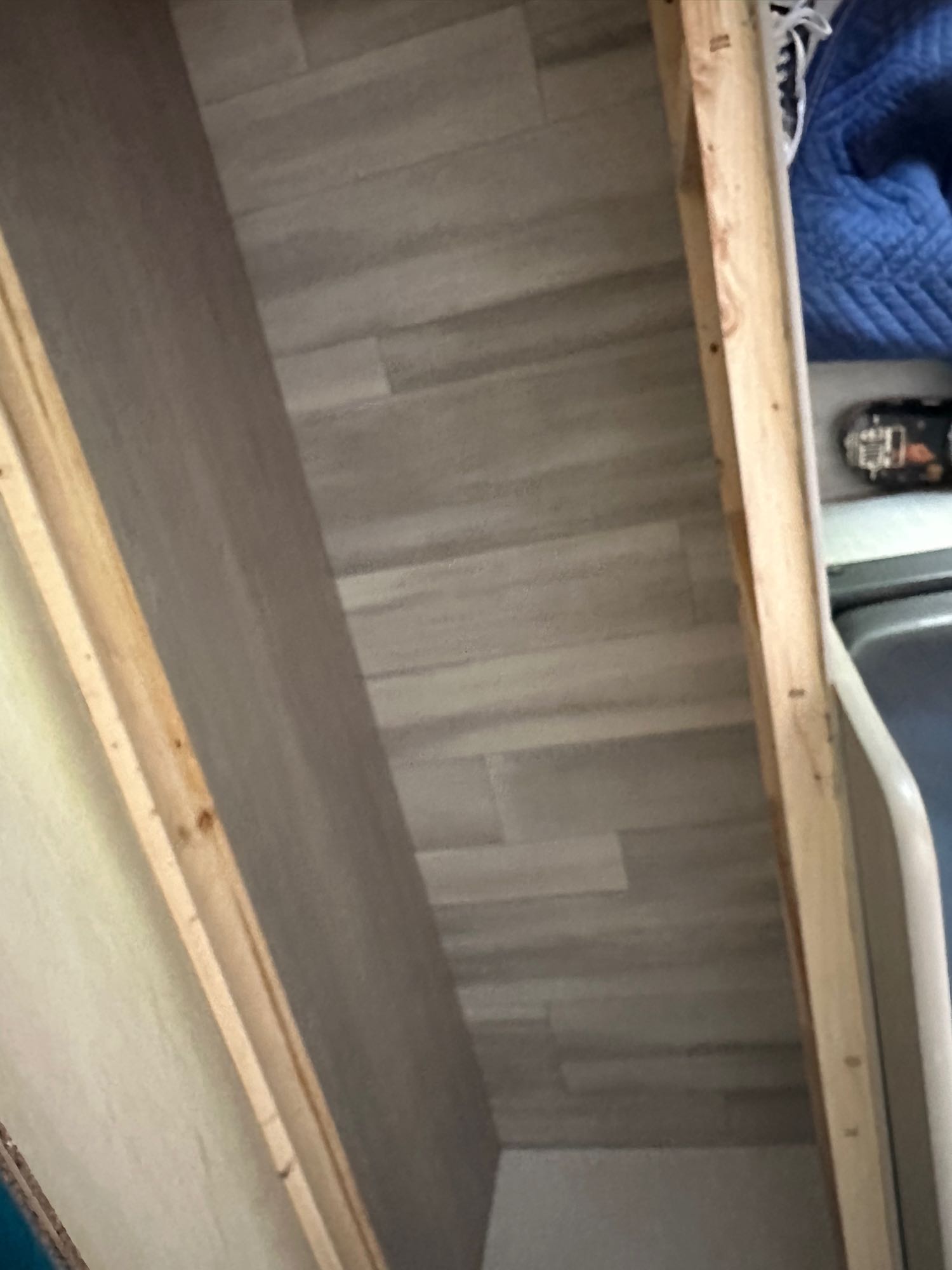 RV rental interior: A utility or storage space featuring light plank flooring, wooden framing, and a partial appliance.. Keystone RV Springdale 2024