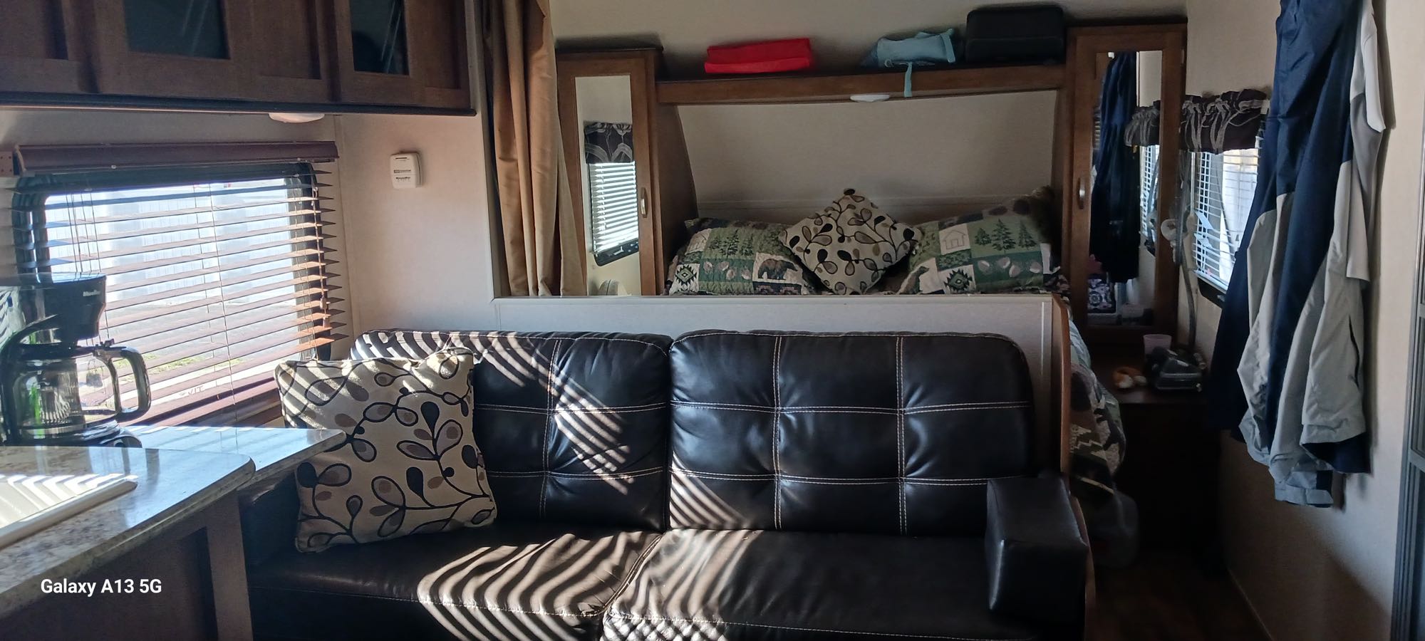 Cozy RV rental interior showcasing comfortable living space, kitchenette, and sleeping area – perfect for road trip adventures.. Forest River Salem Cruise Lite 2018
