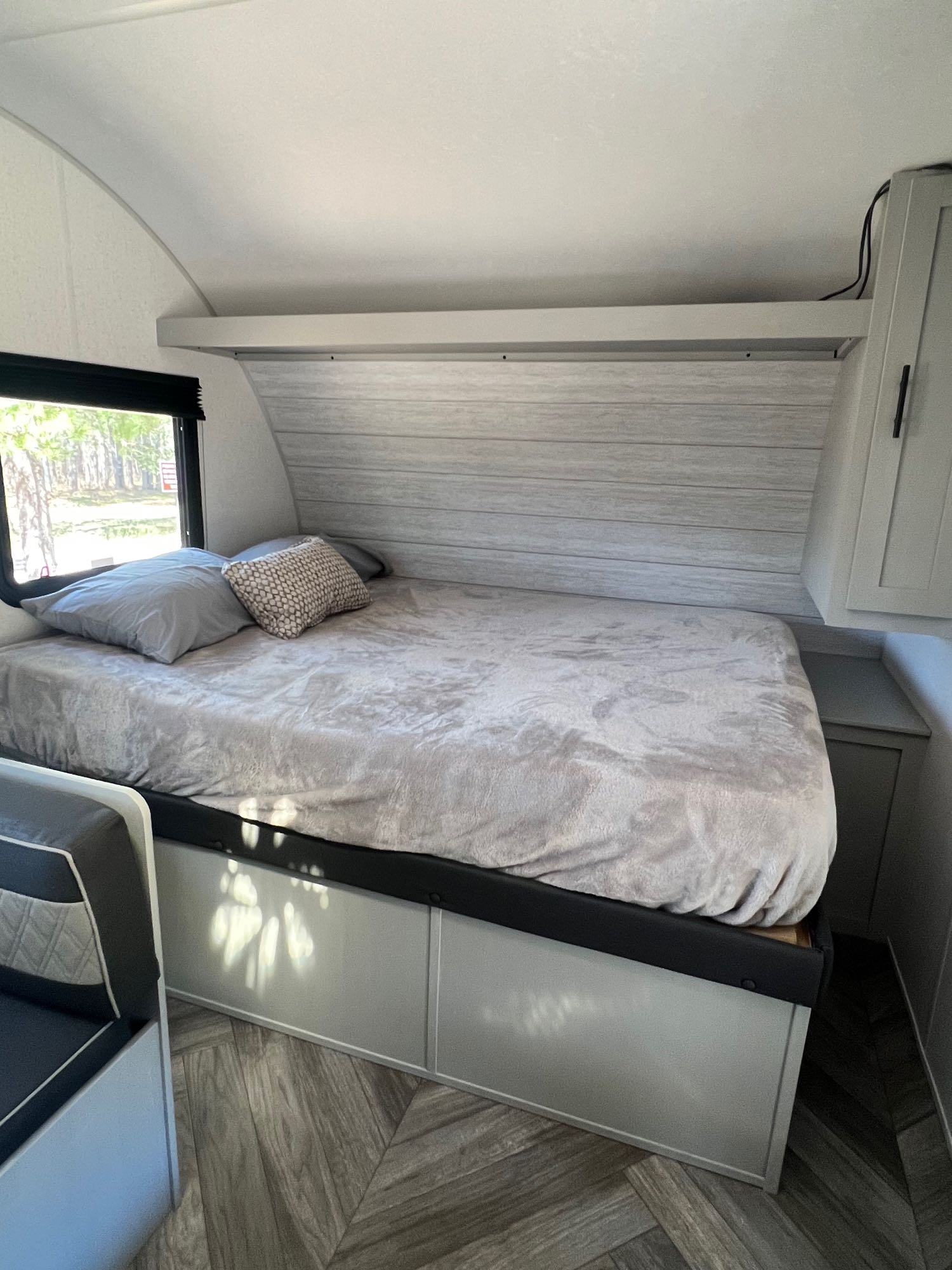 Cozy RV rental bedroom featuring a comfy bed, large window, and ample built-in storage.. Forest River Salem FSX 2022