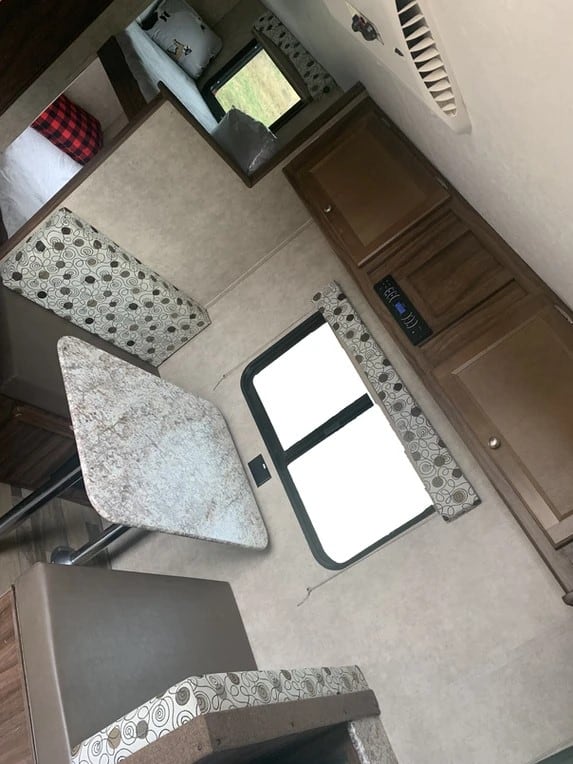 Inside this RV rental: cozy dinette, bunk beds, and ample storage. Ideal for family travel adventures.. Coachmen Clipper 17BH 2018