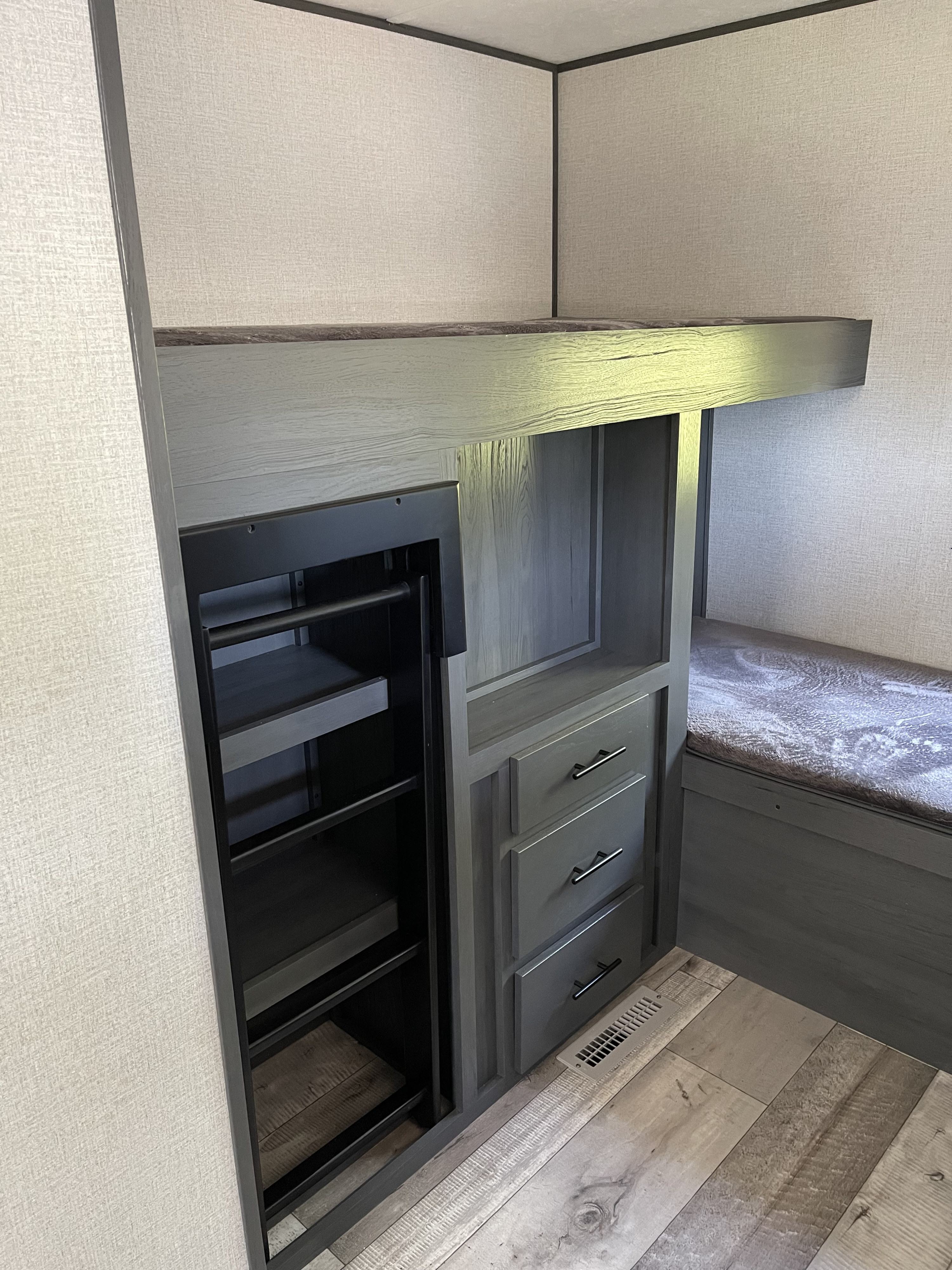 RV rental bunkhouse interior: modern storage unit with pull-out shelves, dresser, and bench seating.. Aspen Trail Aspen Trail Trailer 2021