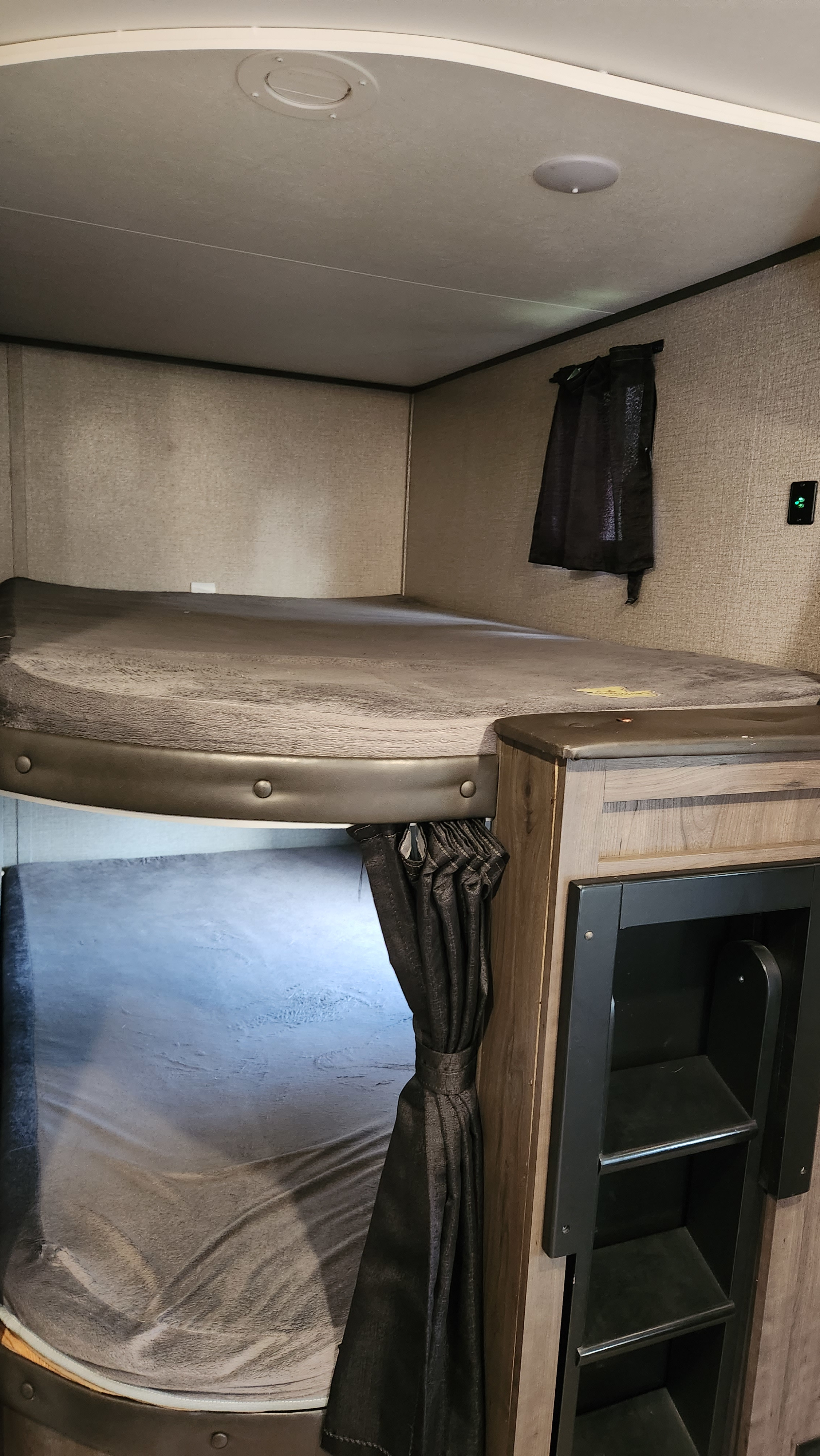 Cozy RV rental bunk beds with gray mattresses & storage unit. Perfect sleeping area for trips.. Jayco Jay Flight 2021