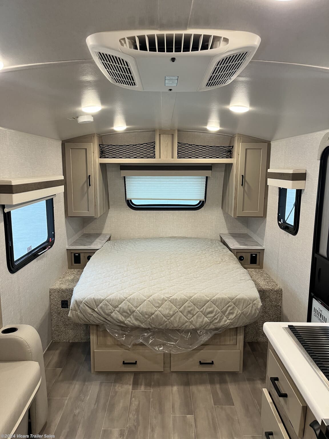 This RV rental offers a clean, comfortable bedroom with a large quilted bed, overhead AC, and built-in storage.. Forest River Rockwood Geo Pro 2023