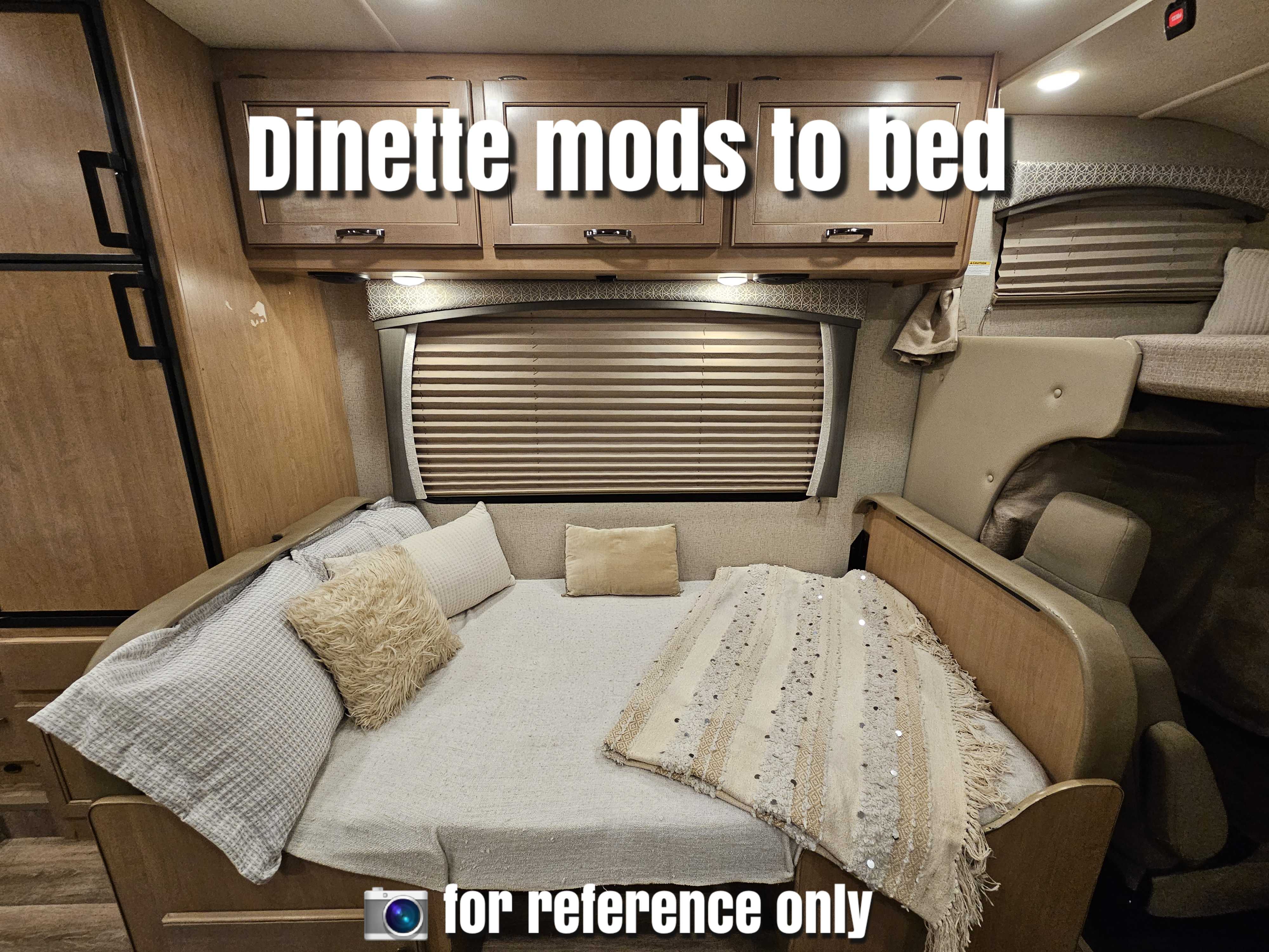 This RV rental interior features a dinette cleverly converted into a comfortable bed, complete with pillows and blankets.. Thor Motor Coach Four Winds 2021