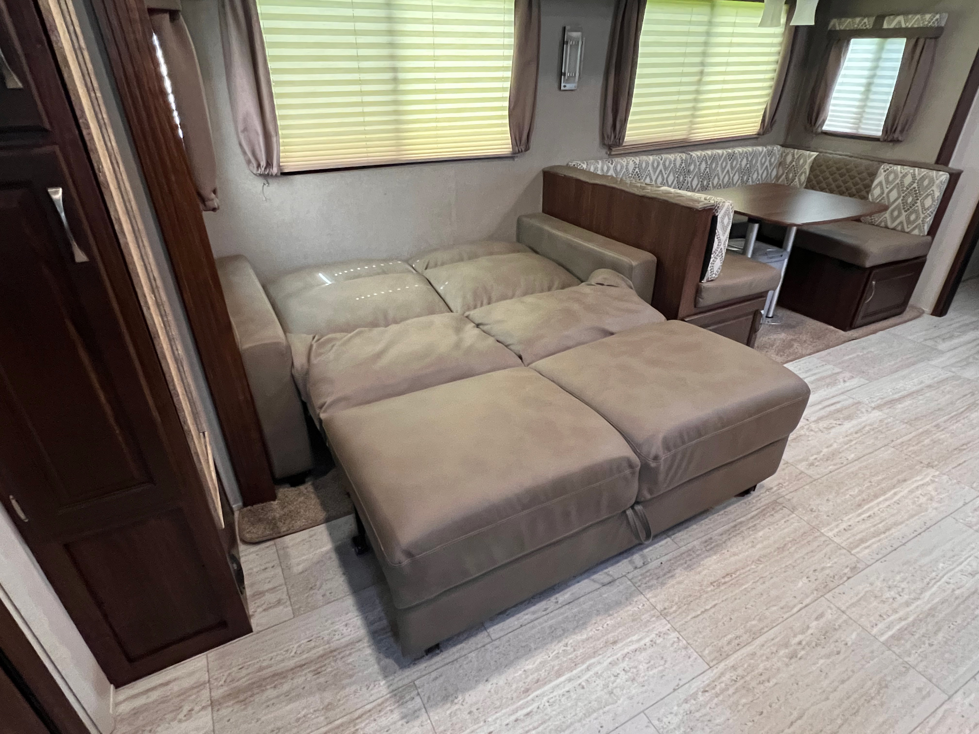 Explore this RV rental's versatile interior: extended sofa bed, dinette with seating, perfect for compact living.. Forest River Solaire 2020