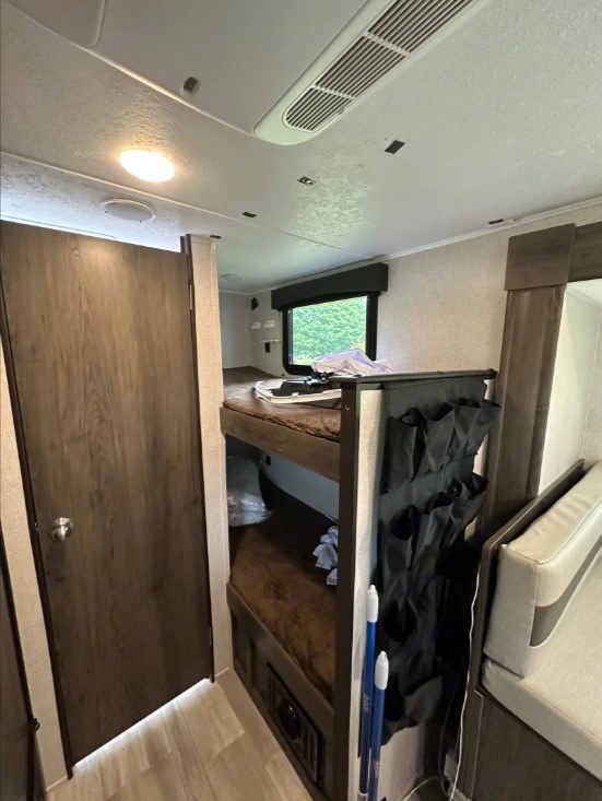 Experience an RV rental: Interior view reveals bunk beds, a door, and window in a compact travel trailer.. Clipper Clipper Trailer 2021