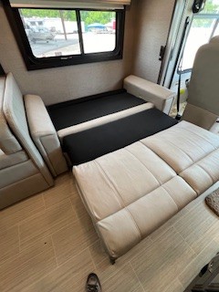 Partially extended sofa bed inside a clean RV rental, offering versatile sleeping options for your journey.. Entegra Coach Vision XL 2023