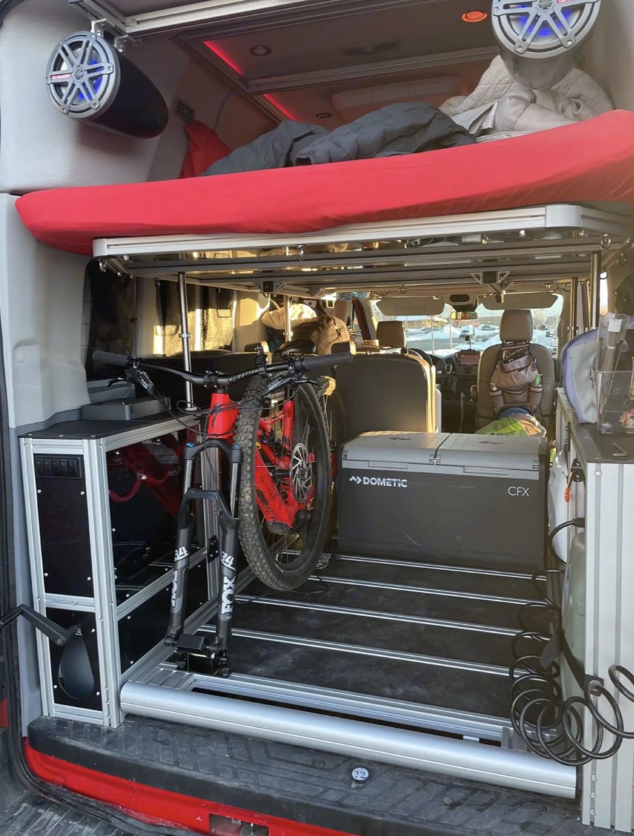 Adventure-ready RV rental: built-in bike mount, bed, and fridge inside a spacious camper van.. Ford Transit 2016